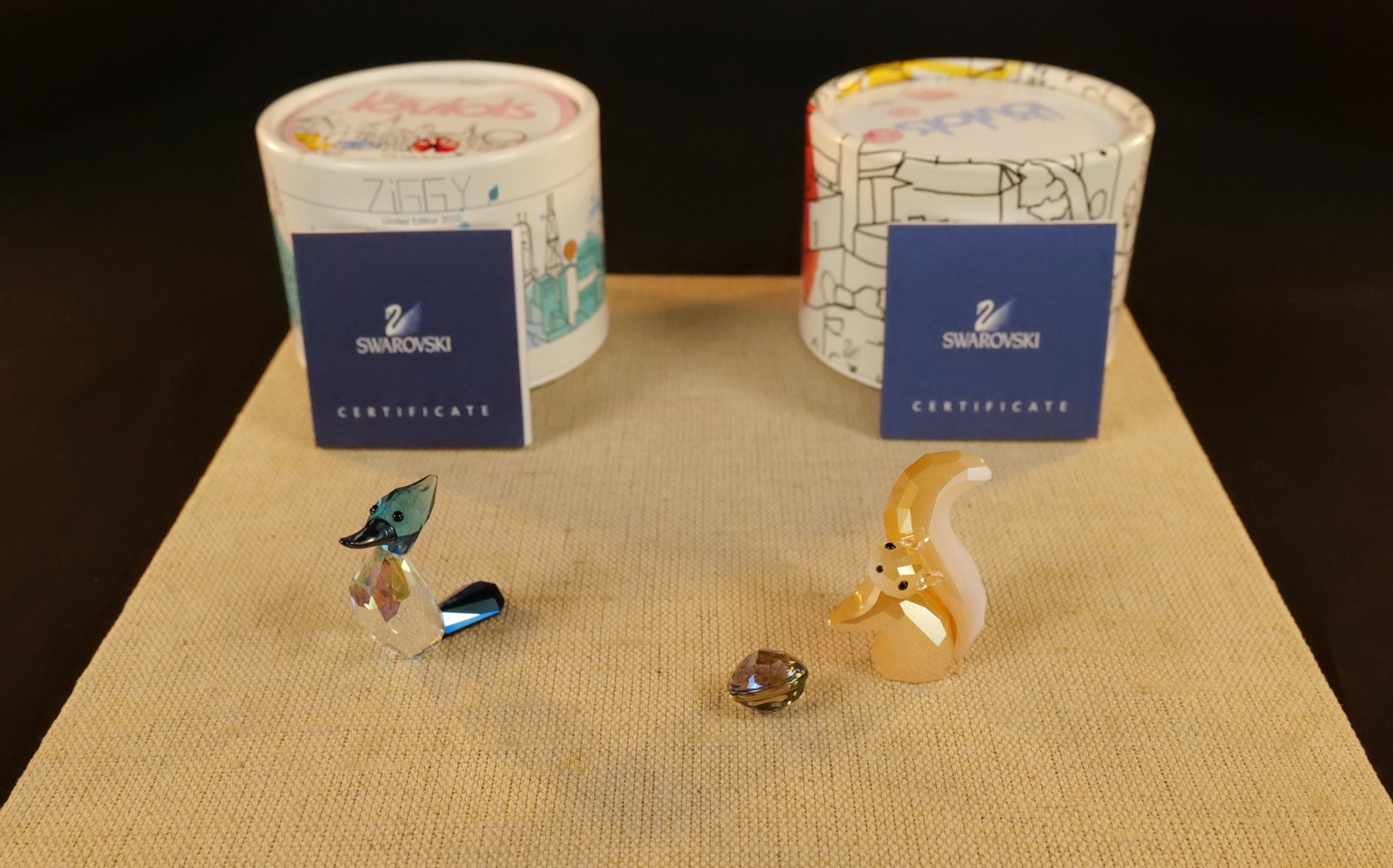 Group of 2 Swarovski Lovlots Figurines: Group of 2 Swarovski Lovlots Figurines including Woodpecker and Gracy the Squirrel - His nut has come loose and just needs to be reattached. Largest measures 1.5" tall. Both come in the original boxes