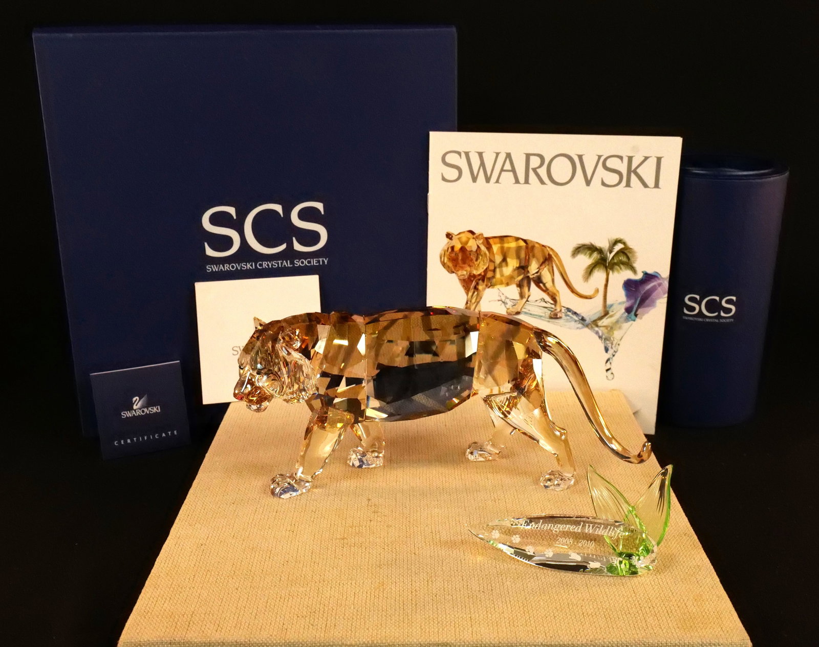 Swarovski Endangered Wildlife Tiger Figurine with Plaque: Swarovski Crystal Endangered Wildlife Tiger Figurine with Plaque - SCS Annual 2010. Item #1003148. Also includes Endangered Wildlife Plaque Dated 2008-2010. Tiger measures 3.25" tall x 7.25" long. Bot