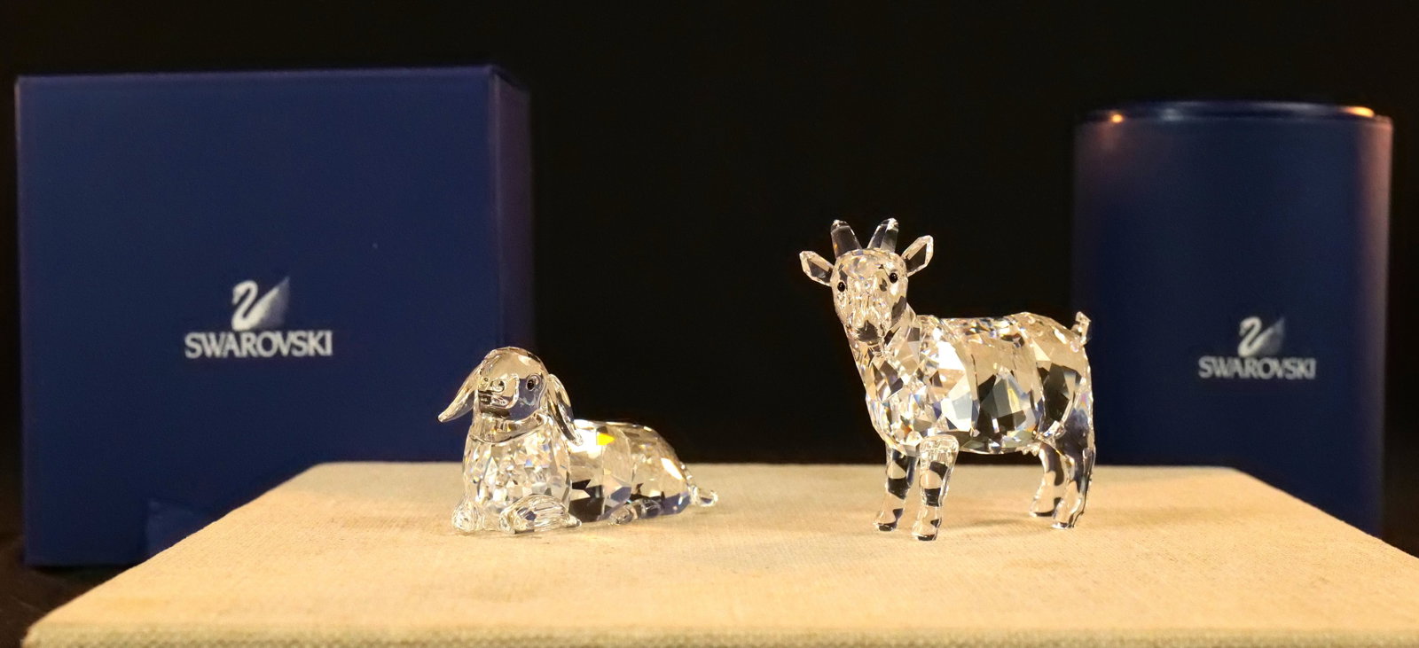 Lot of 2 Swarovski Crystal Farm Animal Figurines: Lot of 2 Swarovski Crystal Farm Animal Figurines including Goat #897351 and Mother Sheep Laying #631437. Largest measures 2.5" tall. Both come in original packaging. All invoices must be paid within 2
