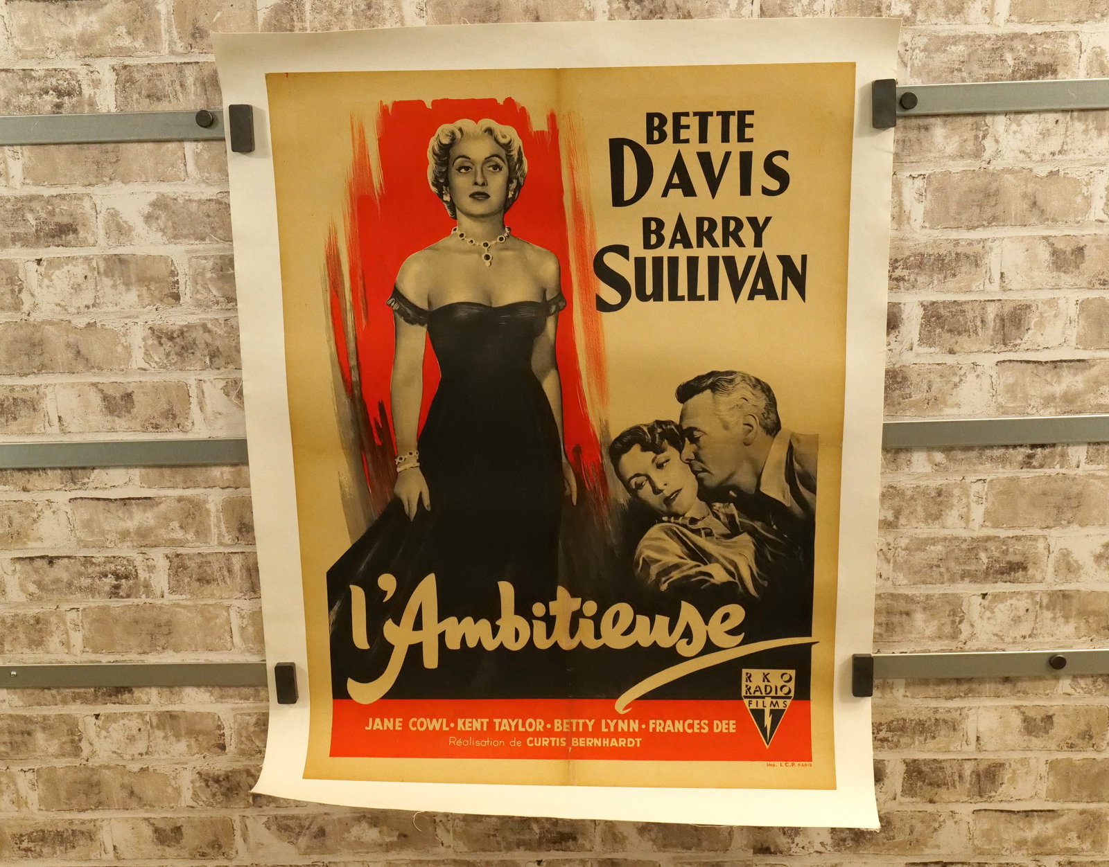 Foreign L'Ambitieuse Movie Poster: Foreign L'Ambitieuse Movie Poster - Linen Backed. Starring Bette Davis and Barry Sullivan. Has color touch ups to center seam and bottom center had obvious tear before mounting. All have minor tearing