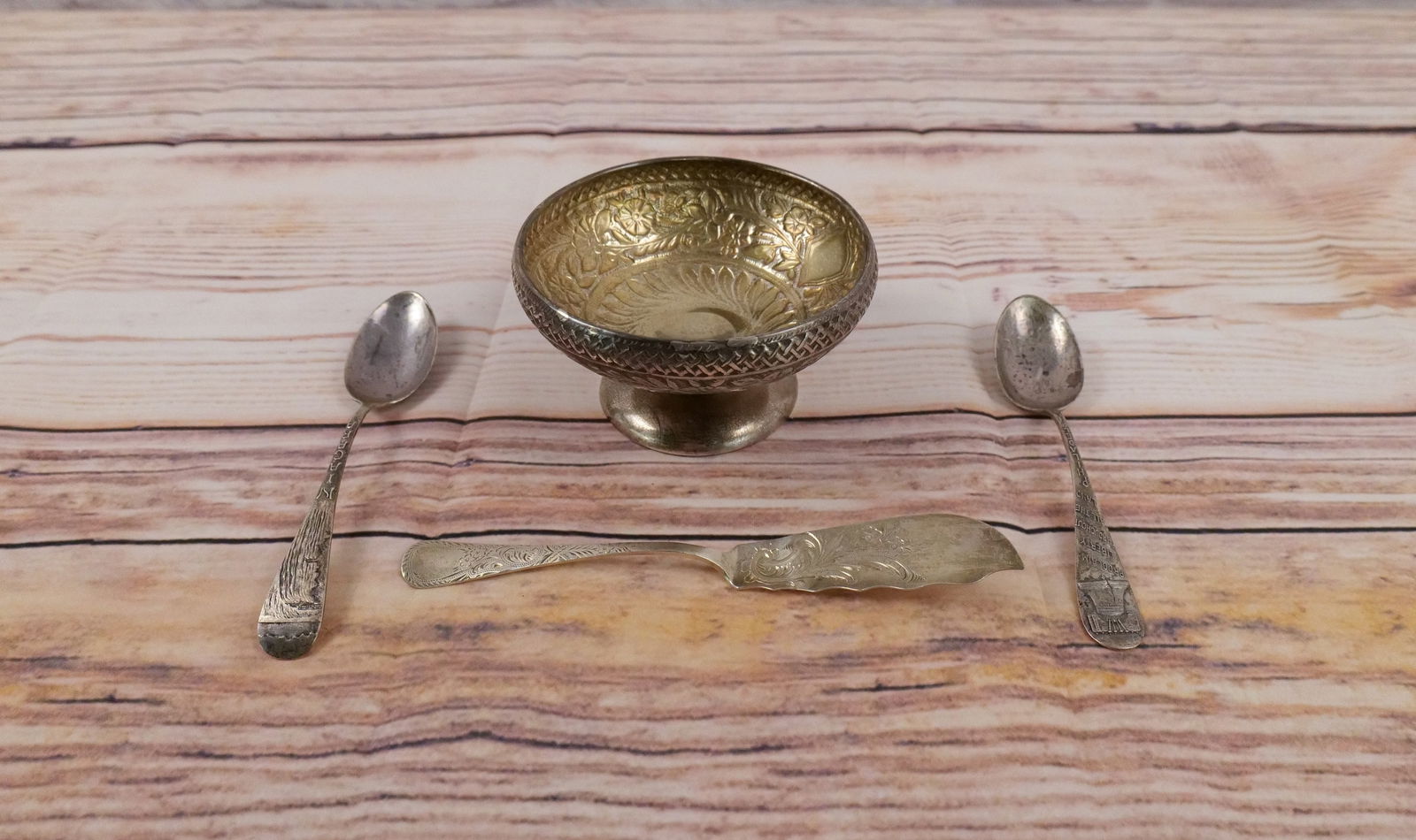 Group Lot of Sterling Silver: Group Lot of Sterling Silver. Lot contains a Gorham Open Waste A9776, Gorham butter knife, Philadelphia Liberty Bell Spoon and a Niagara spoon. Open waste measures 2.5" tall by 4.5" wide. Weighs appro