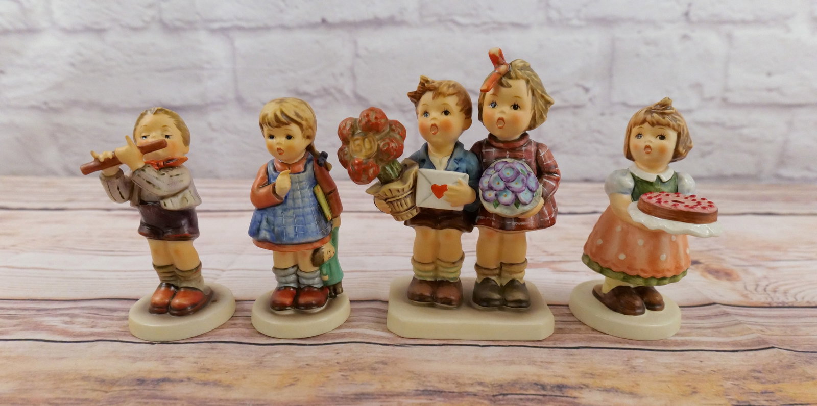 Lot of 4 Hummel Figurines: Lot of 4 Hummel Figurines including "The Love Lives On", "Morning Concert", "I Wonder" and "Birthday Candle". All TMK 7. All are in good condition. Largest measures 6.75" tall. All invoices must be pa