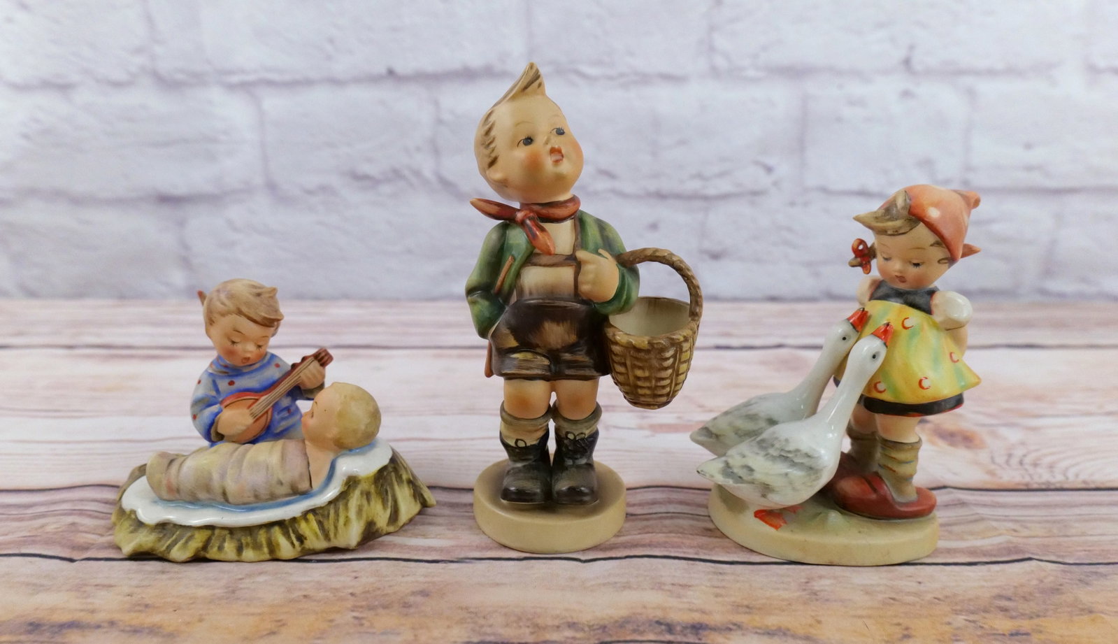 Lot of 3 Hummel Figurines: Lot of 3 Hummel Figurines including "Goose Girl" , "Lullaby", and "Village Boy". Village Boy has a chip on bottom of the base. All TMK 1 & 2. All others are in good condition with some normal craze. L