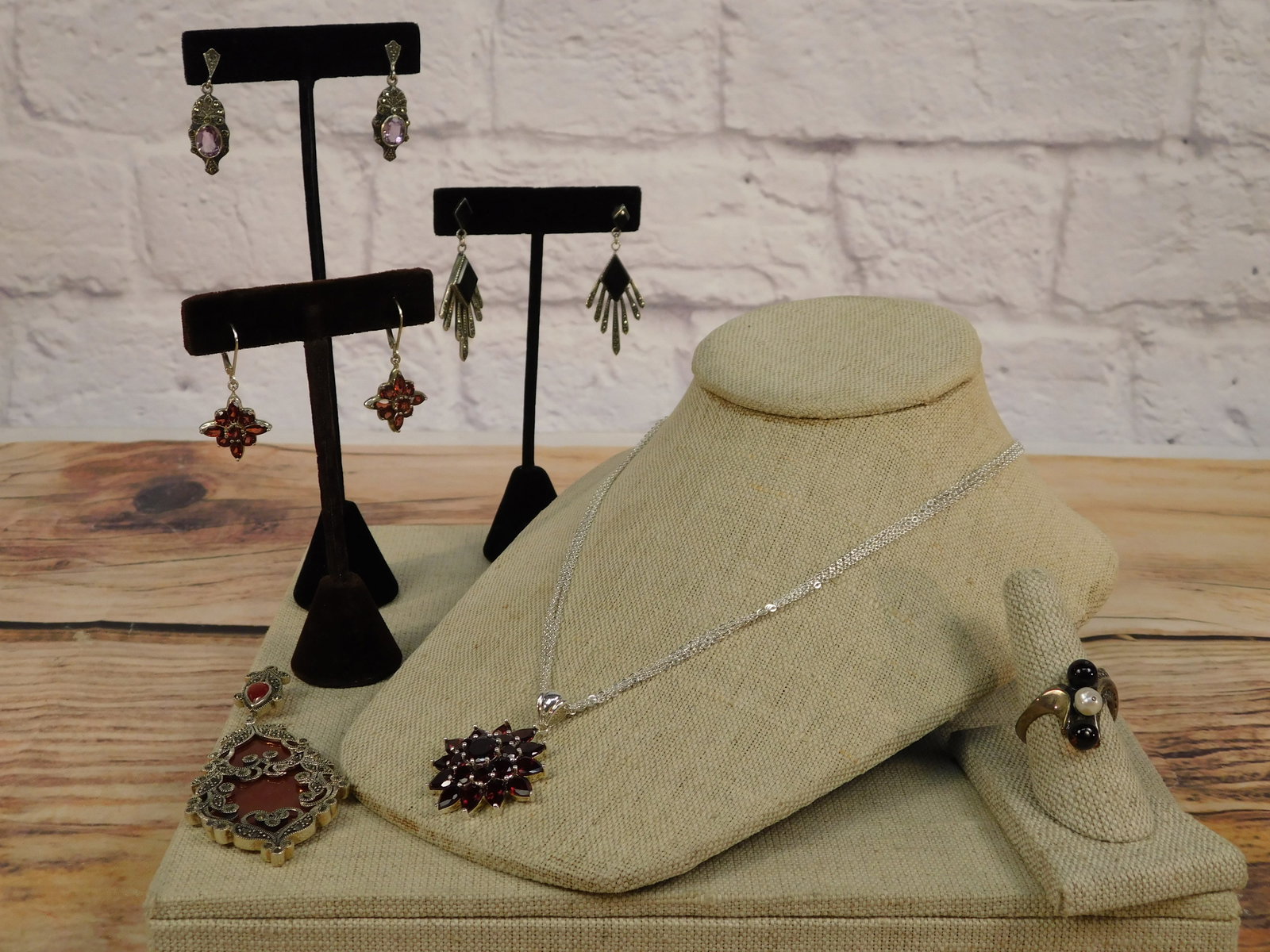 Group of Sterling and Gemstone Jewelry: Group of Sterling and Gemstone Jewelry including a large scroll worked overlay pendant set with marcasite's backed with a large slab of carnelian and a decorative double bail with a bezel set 9mm x 6m