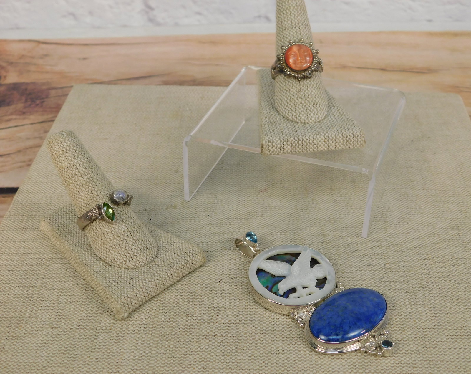 Group of Sterling Sajen Jewelry: Group of sterling Sajen jewelry including an oversized pendant with a Carved Mother of Pearl Eagle over an abalone Disk Circle with an oval cabochon Lapis natural stone and 2 Topaz on the top and bott