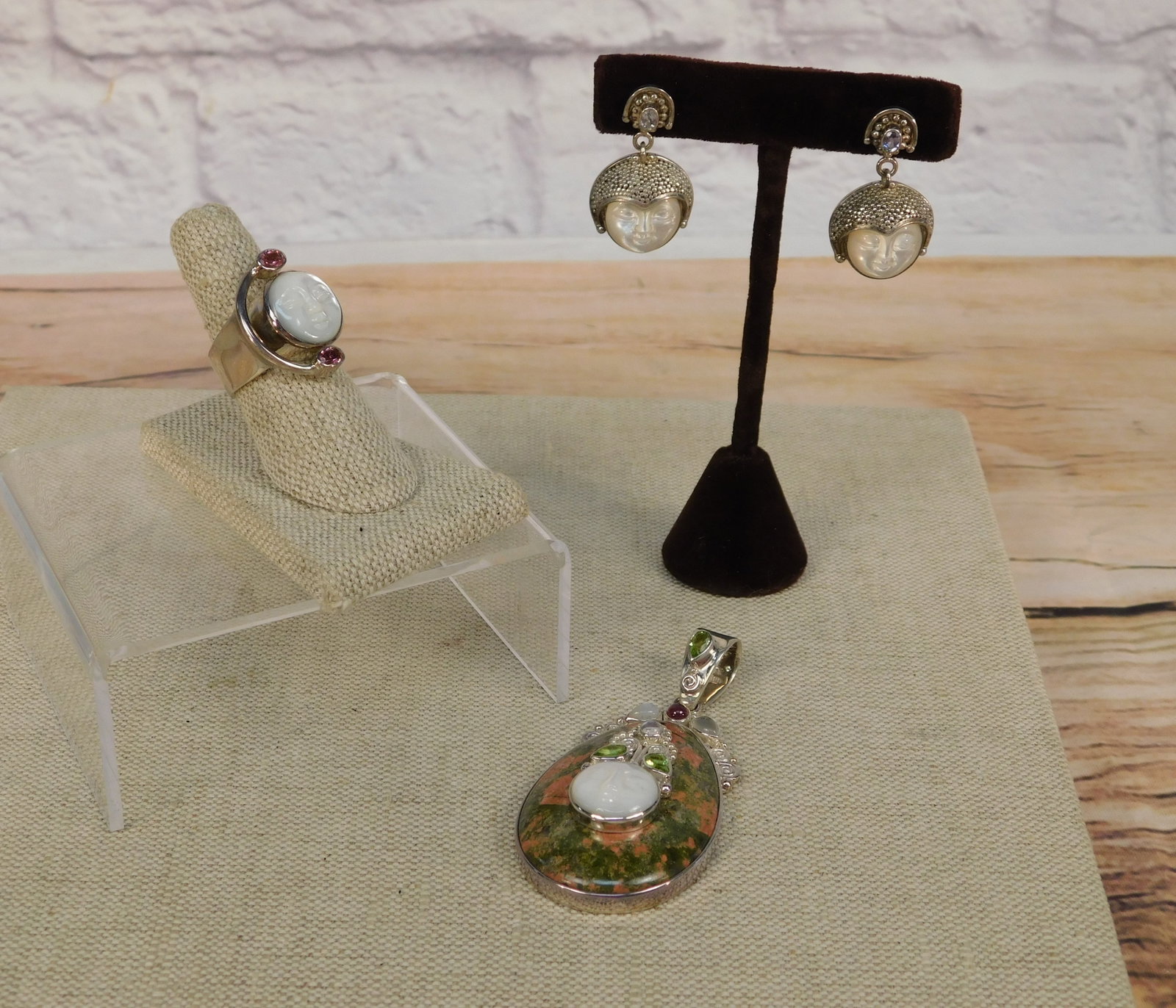 Group of Sterling Sajen Jewelry: Group of sterling Sajen jewelry including an oversized pendant with a pear shaped Cabochon Jasper, Carved Mother of Pearl Face with Peridot, Garnet & Moonstone, a ring with a Mother of Pearl carved fa