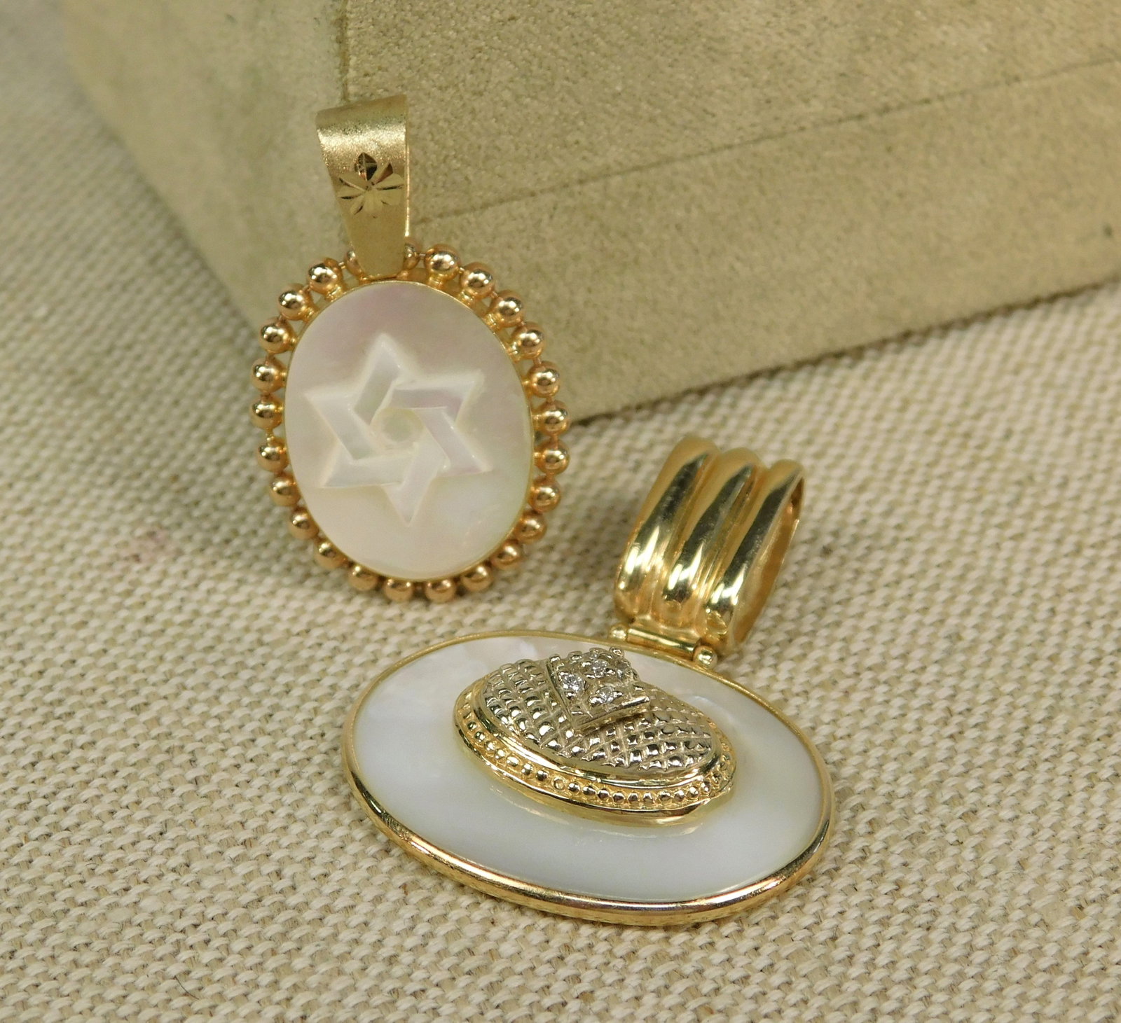 Group of Mother of Pearl and 14K Pendants: Group of Mother of Pearl and 14K Pendants. Group includes an Oval Pendant Set North to South featuring Carved Mother of Pearl Inset with the Star of David and a Gold Bead Halo with Etched Accents meas