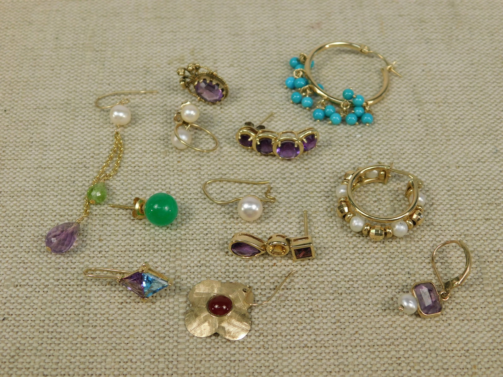 Group of 14k Scrap Earrings: Group of 14k Scrap Earrings including 11 Different Single Gold Earrings in a variety of styles. Most are set with semi precious stones including Citrine, Peridot, Citrine, Carnelian, Topaz and More. B