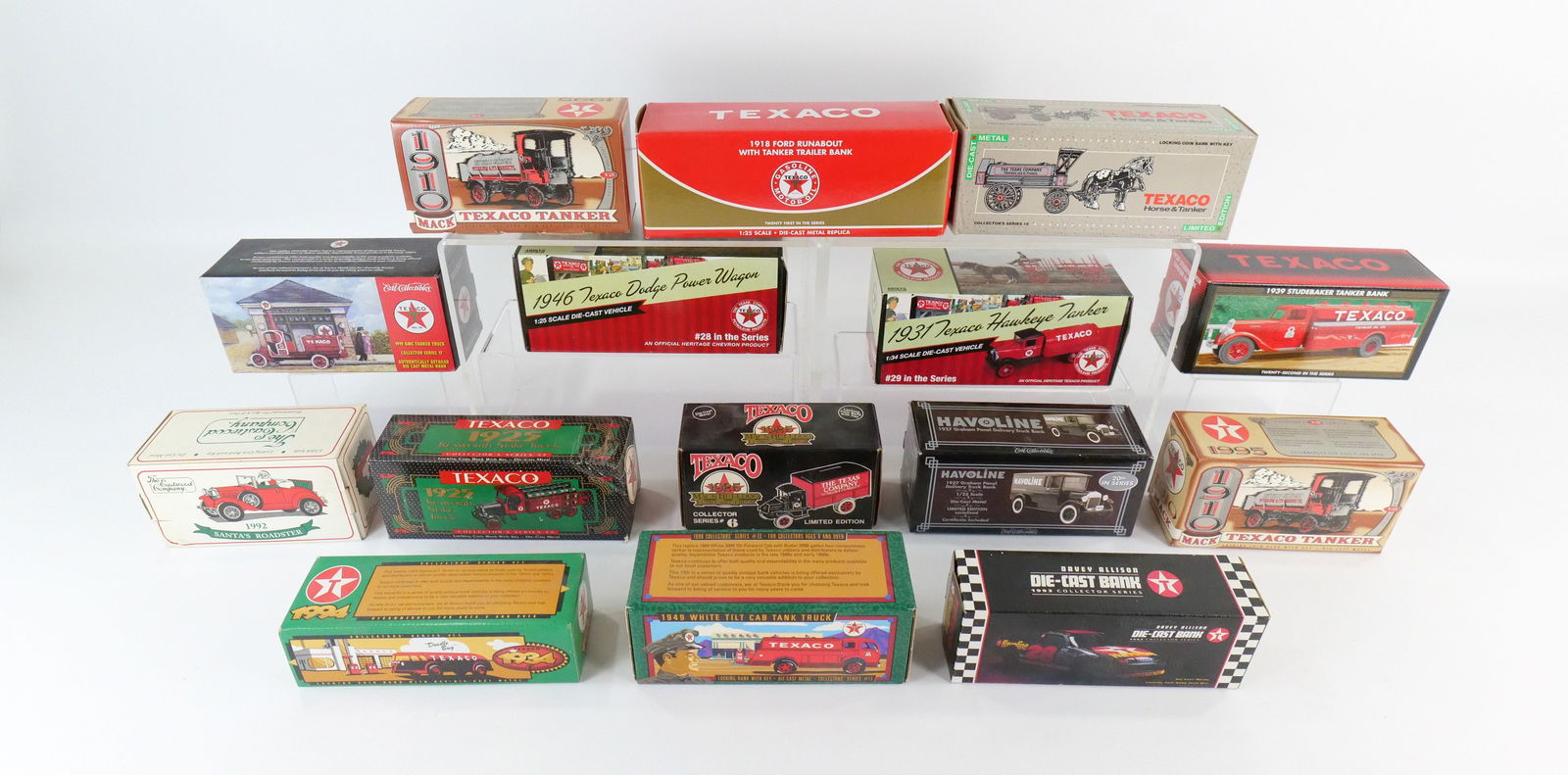 Lot of 15 Diecast Banks: Lot of 15 Diecast Banks including Texaco from Various Makers (Ertl, RC2), and Eastwood Santa's Roadster. All new in original boxes. All invoices must be paid within 24 hours of the sale. We offer mult