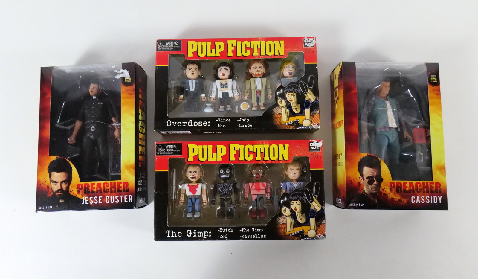 Lot of NECA Pulp Fiction and Preacher Collectibles: Lot of NECA Pulp Fiction and Preacher Collectibles including Preacher Cassidy & Jesse Custer Figures, and Pulp Fiction Geoms - Overdose & The Gimp. All sealed in packages. All invoices must be paid wi