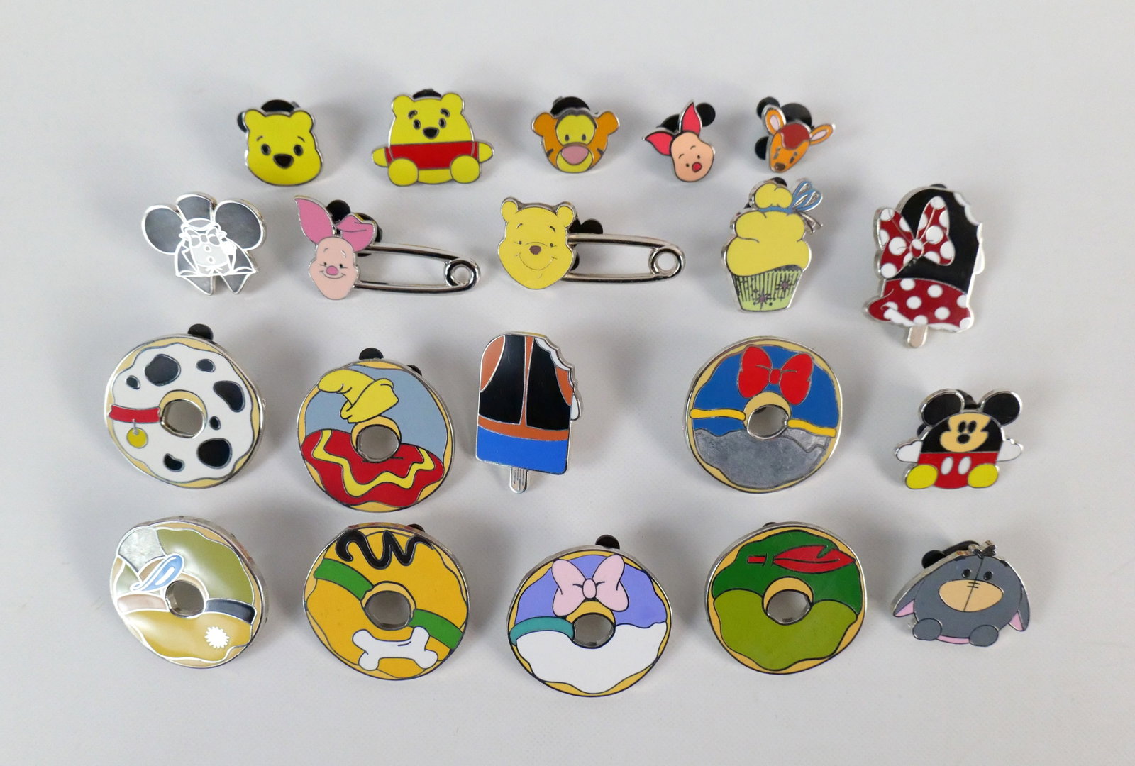 Lot of 20 Mixed Disney Pins: Lot of 20 Mixed Disney Pins including Character Donuts, Character Ice Cream, Clothespins, Winnie the Pooh Faces, and More. Many are Hidden Mickey Pins. All invoices must be paid within 24 hours of the
