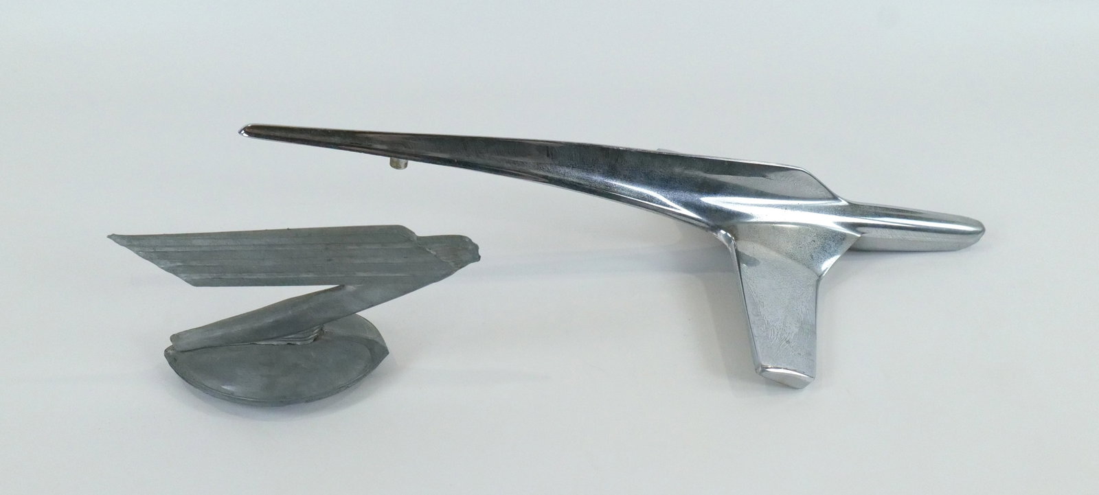 Lot of 2 Art Deco Car Hood Ornaments: Lot of 2 Art Deco Car Hood Ornaments. Radiator Hood Ornament depicting Woman's Face with Wing in Motion - Marked Norlipp 80 Chicago USA. Other marked BN16853. Largest measures 17.25" long. All invoice