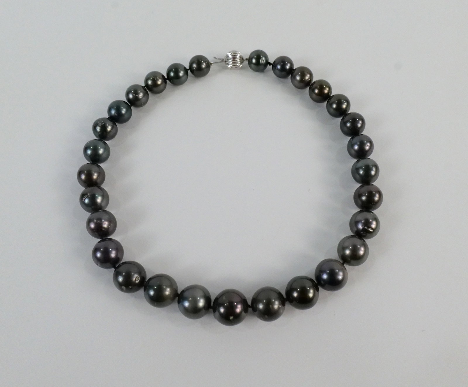 Cultured Tahitian Pearl Necklace: Cultured Tahitian Pearl Necklace. Single Strand. Measures 18" long. Finished with 14K White Gold Plunger Style Bead Clasp. Contains 29 Pearls measure 13-15 mm. Comes with AIGL Report. All invoices mus