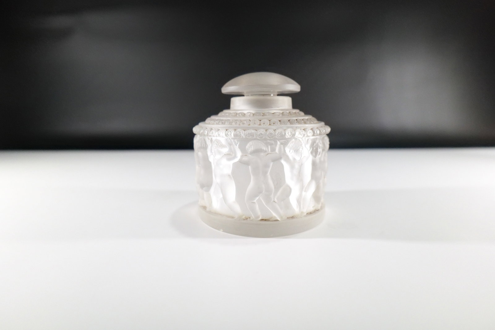 Lalique Enfants Perfume Bottle: Lalique Enfants Perfume Bottle. Signed on bottom. Good Condition - Smells like perfume. Measures 4" tall x 4" diameter. All invoices must be paid within 24 hours of the sale. We offer multiple shippin