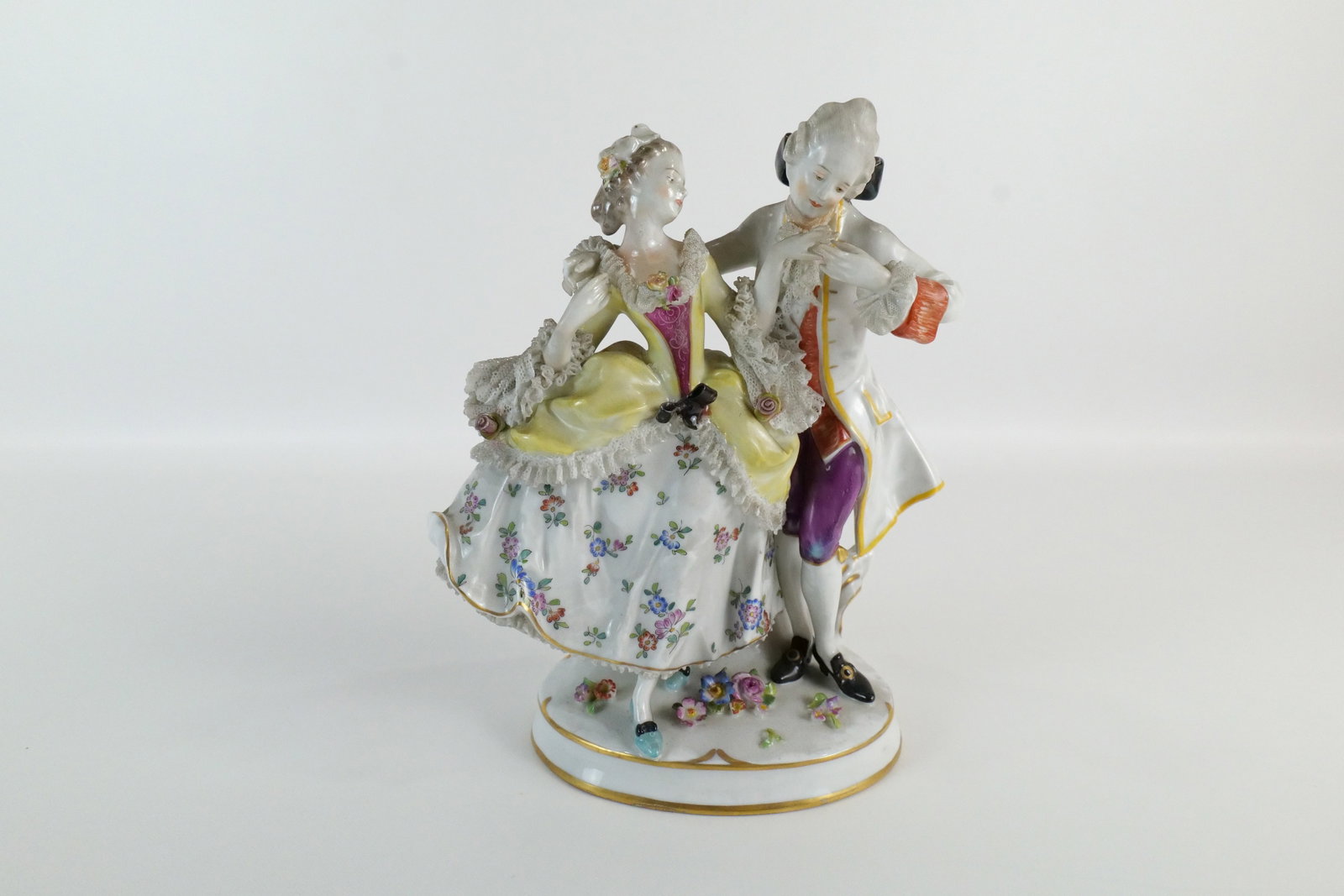 19th Century German Porcelain Figurine: 19th Century German Porcelain Figural Grouping of Man and Woman Dancing. Hand Painted with Decorative Lace. Has German Marking on Back. Lace appears to be 99% intact. Figurine in good condition. Measu