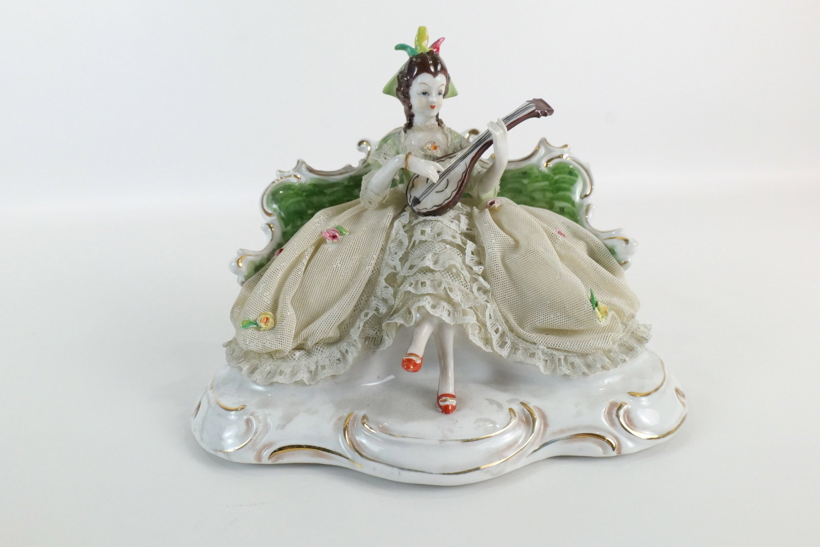 Dresden Style Porcelain Figurine - Early 20th Century: Early 20th Century Dresden Style Porcelain Figurine. Depicting Woman Seated Playing Mandolin. Good Condition. Measures 6" tall x 8" wide. All invoices must be paid within 24 hours of the sale. We offe