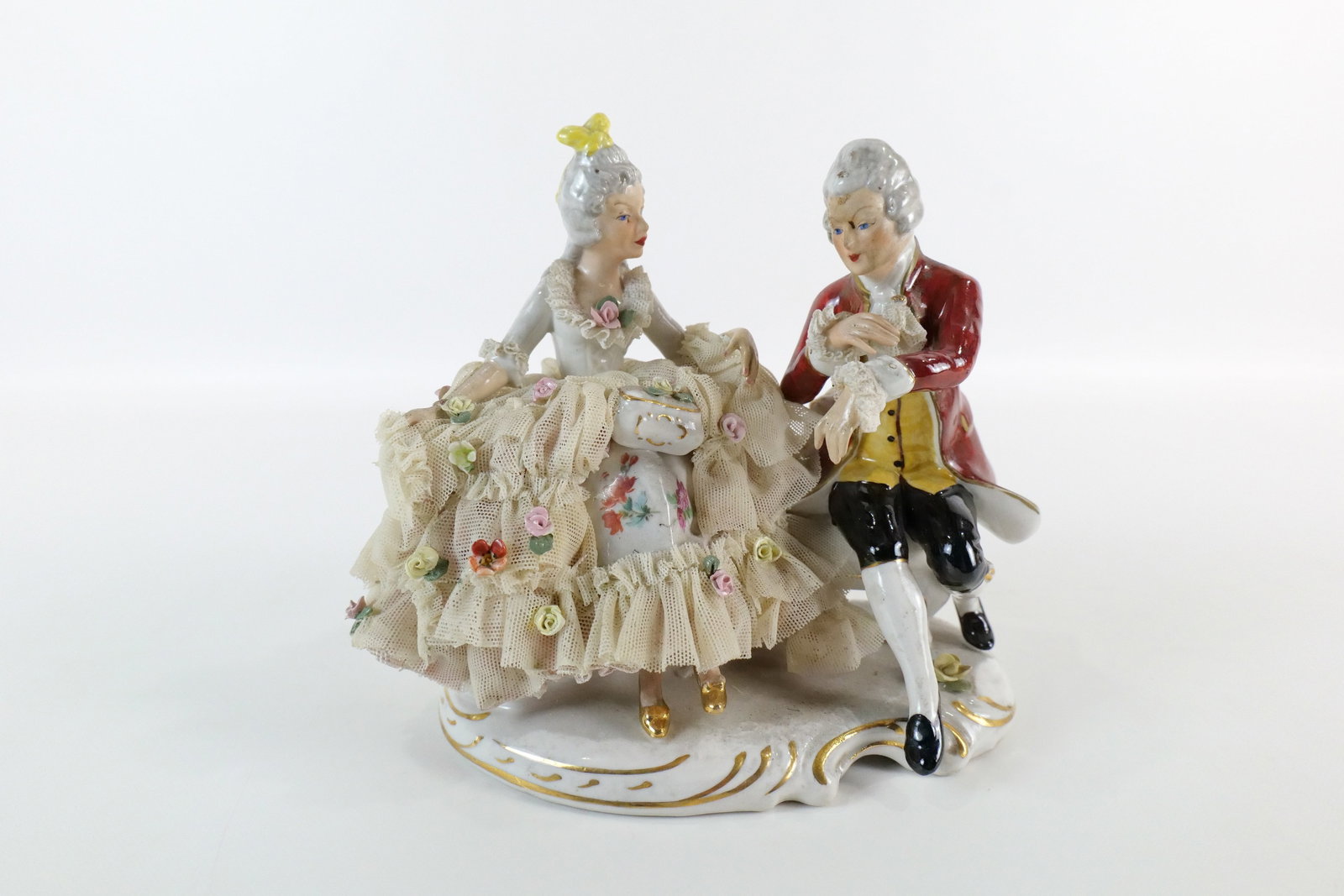 19th Century Capodimonte Dresden Porcelain Figural Grouping: 19th Century Capodimonte Dresden Hand Painted Porcelain and Lace Figural Grouping. Depicting a man and woman seated. Minor loss to lace but mostly intact. Otherwise good condition. Measures 6" tall x 