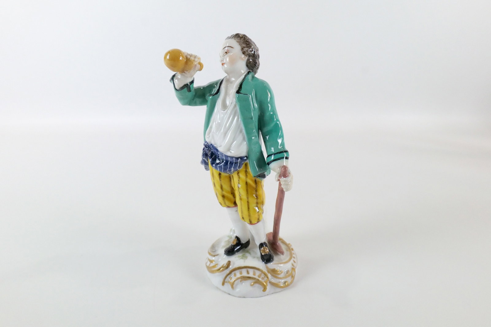 19th Century German Hand Painted Porcelain Figurine: 19th Century German Hand Painted Porcelain Figurine. Depicting a boy hiking and drinking water. Has cross sword marking on bottom. Good condition. Measures 5.5" tall x 3" wide. All invoices must be pa