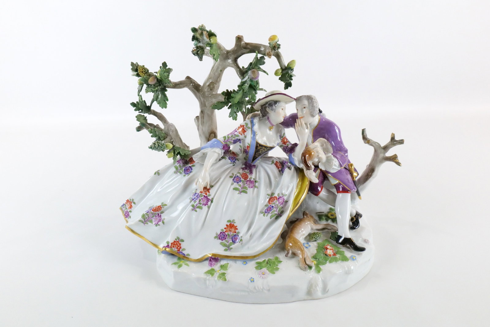 19th Century Meissen Hand Painted Porcelain Figurine: 19th Century Meissen Hand Painted Porcelain Figurine. Depicting a courting couple with a huntsman with a game bird in his hand and a hare laying on the ground in between them. Some loss and chipping t