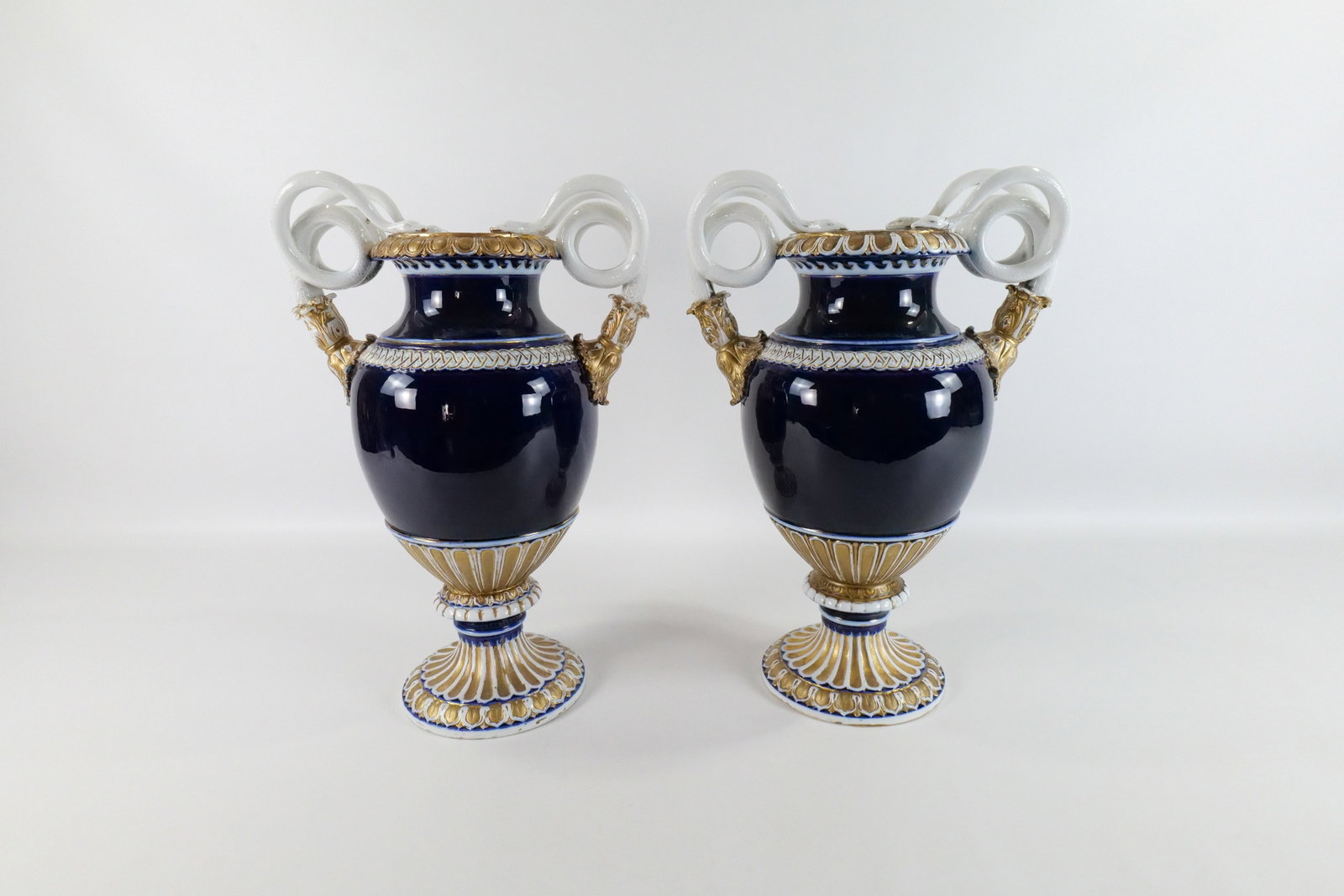 Pair of Meissen Hand Painted Tall Vases: Pair of Meissen Hand Painted Tall Vases. Cobalt Blue with Gold Paint. Has snake decorative handles. Some loss to the gold paint. One of the snake handles has been repaired to one vase. The other vase 