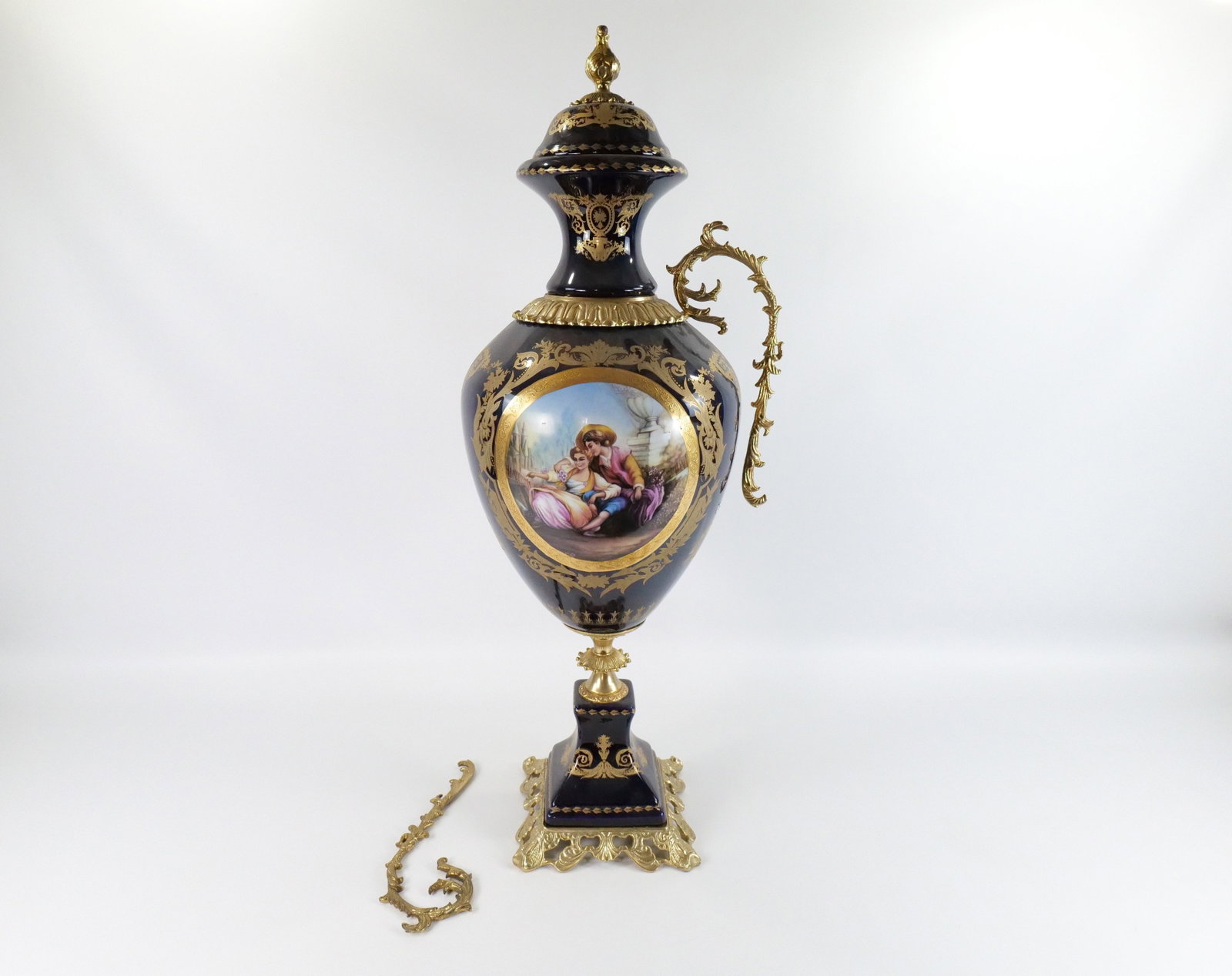 Monumental Limoges Style Covered Urn: Monumental Limoges Style Covered Urn. Hand Painted and Transferware. Cobalt Blue with Brass Accents. Depicting a boy courting a girl. Handle needs to be reattached. Otherwise good condition. Measures 