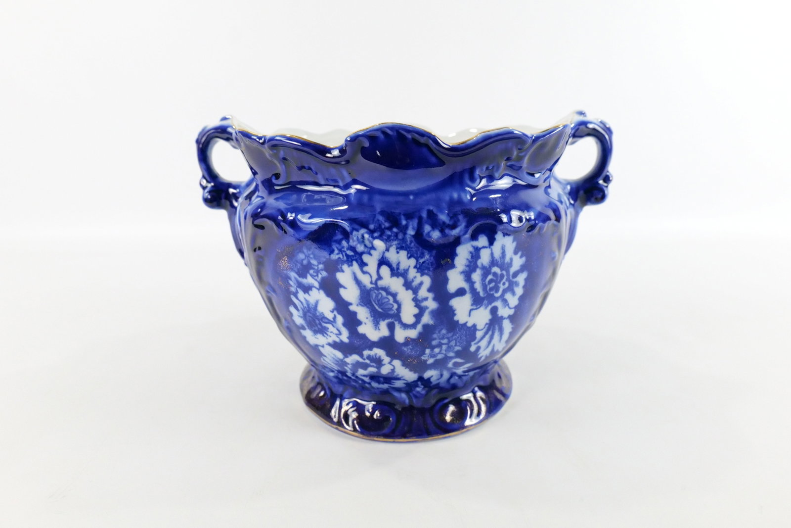 Flow Blue Style Double Handled Planter: Flow Blue Style Double Handled Planter. Bears the Signature Staffordshire England. Good Condition. Measures 9" tall x 12" diameter. All invoices must be paid within 24 hours of the sale. We offer mult