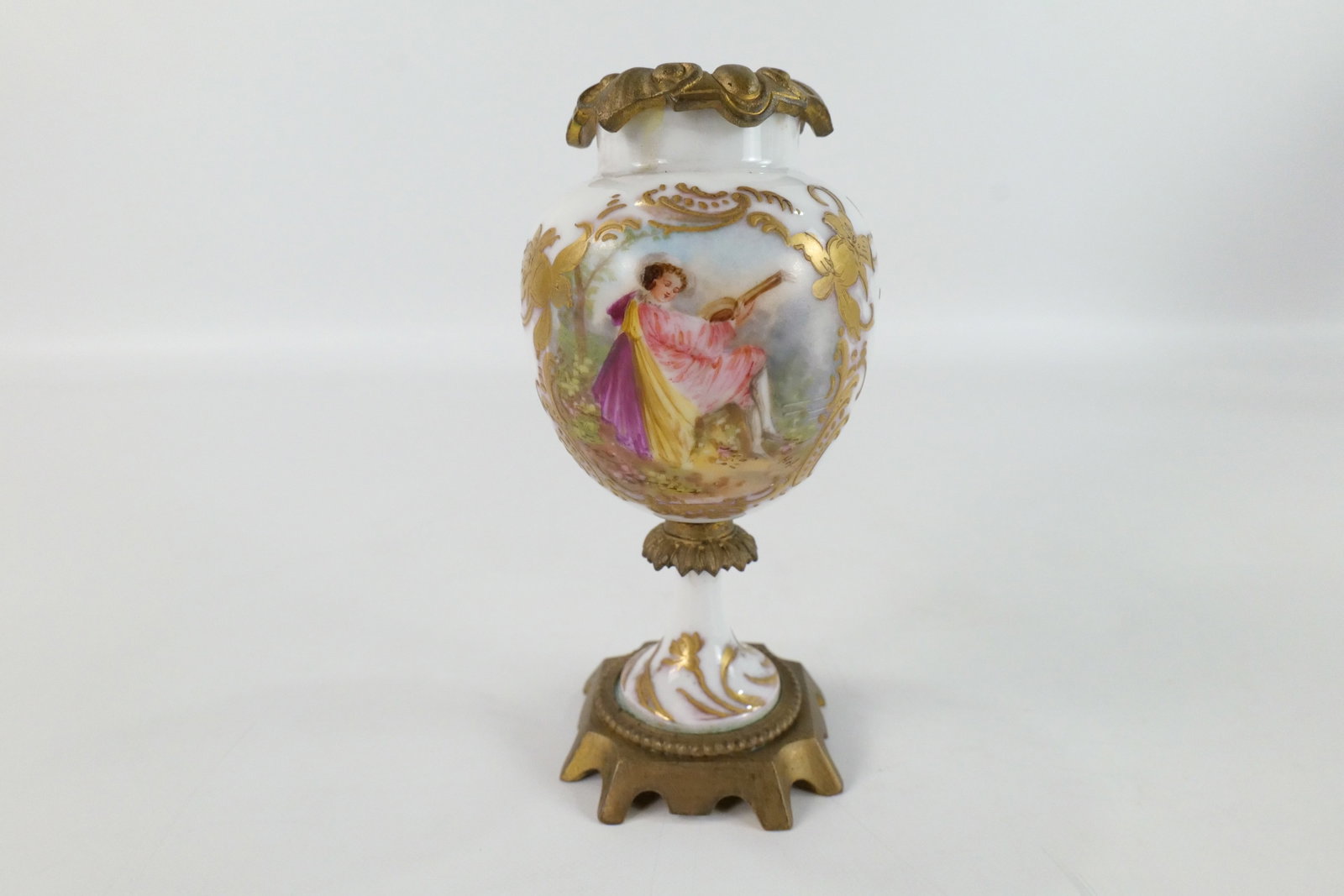 19th Century Sevres Porcelain Urn: 19th Century Sevres Hand Painted Porcelain Urn. Depicting Portrait of Woman playing mandolin. Base marked Serves. Missing lid. Measures 6" tall x 3" diameter. All invoices must be paid within 24 hours