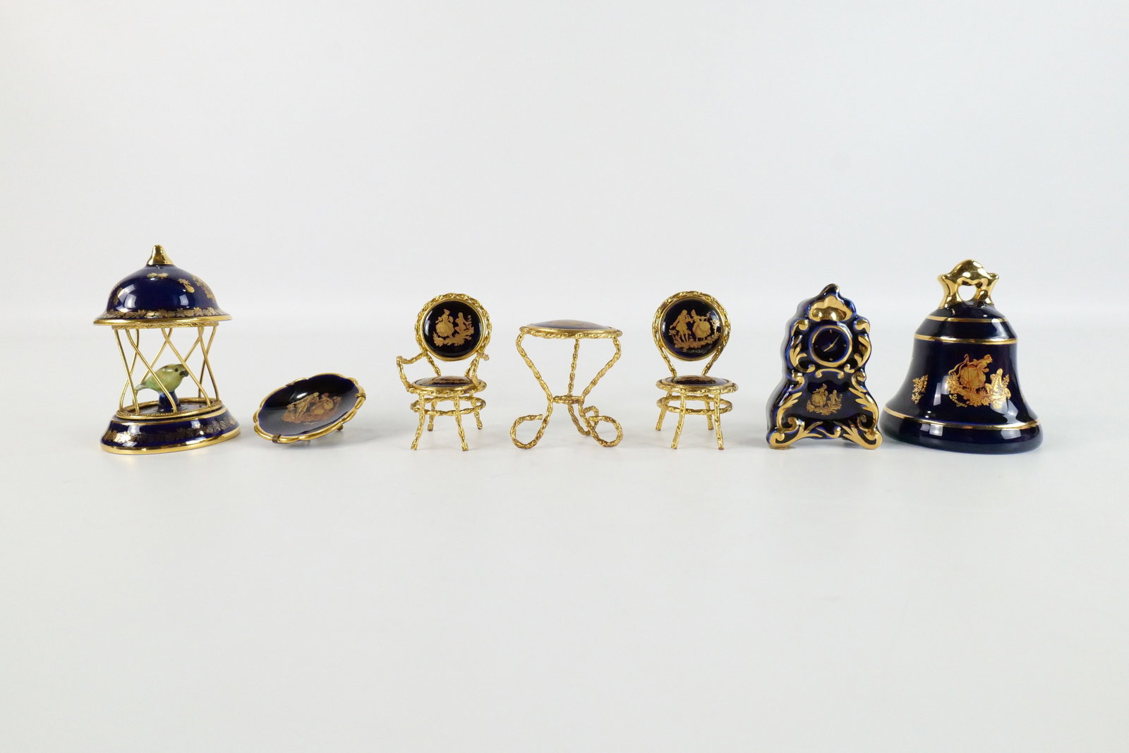 Lot of Limoges Cobalt Blue Miniatures: Lot of Limoges Cobalt Blue Miniatures. Including Birdcage, Bell, Mantle Clock, Table and Chairs, and Miniature Portrait Plate. All marked Limoges. All in good condition. Largest measures 3.5" tall. Al