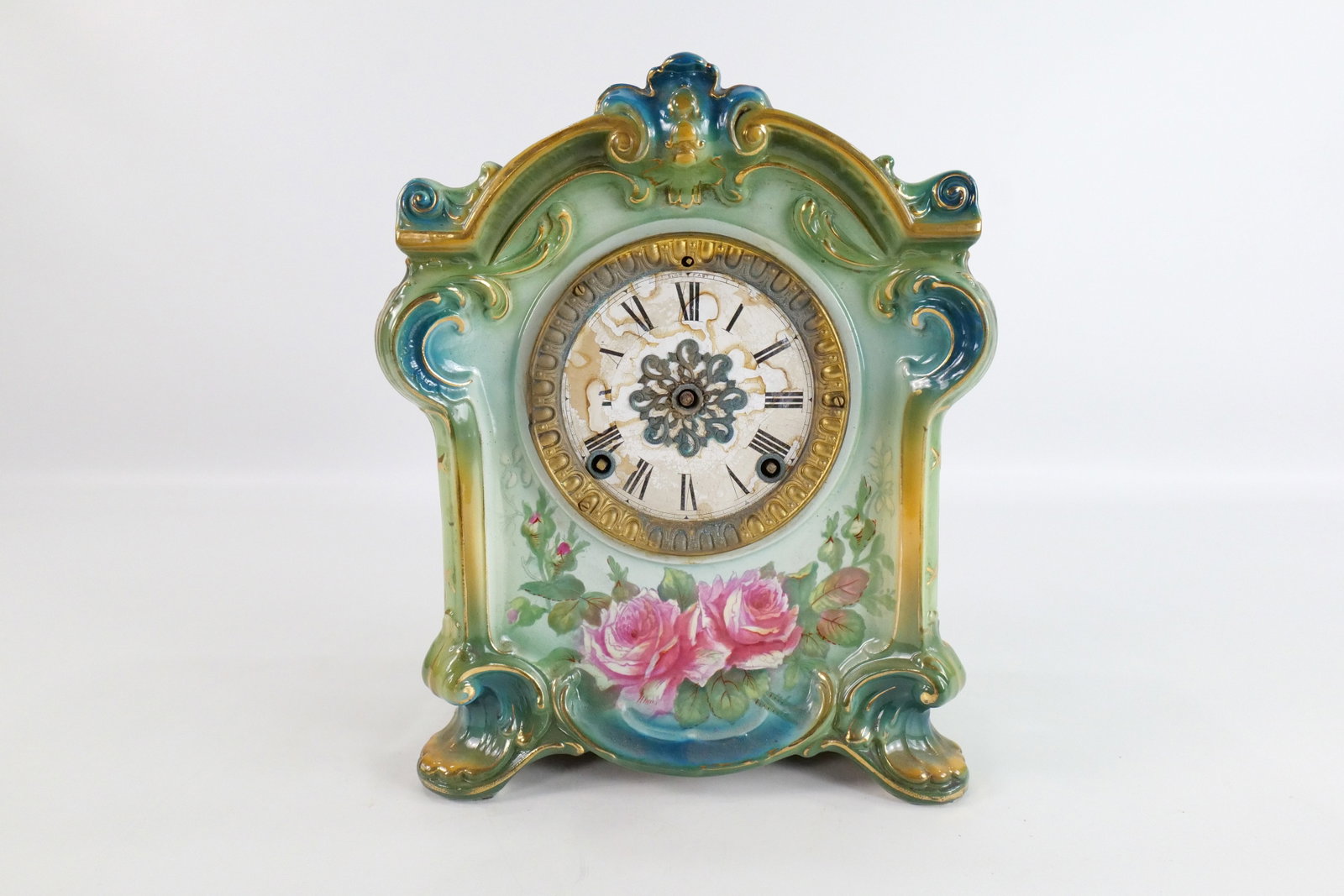 19th Century Royal Bonn Porcelain Mantle Clock: 19th Century Royal Bonn Porcelain Mantle Clock. Has a Rose Decoration. Insignia Works and Clock Face. Missing front crystal, face and works are rusted, missing back plate, and missing hands. Measures 