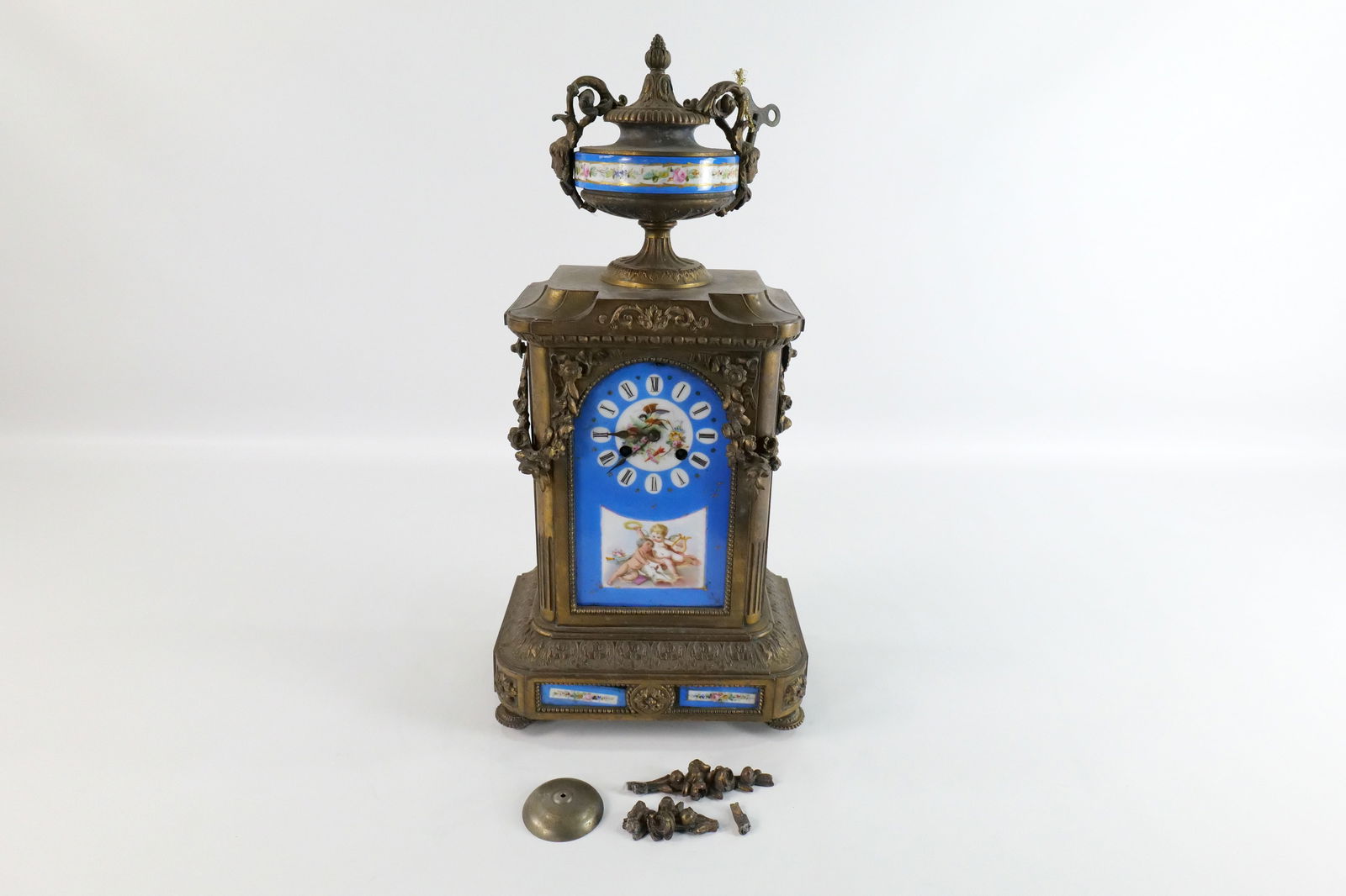 19th Century French Bronze and Porcelain Mantle Clock: 19th Century French Bronze and Porcelain Mantle Clock. Has hand painted Porcelain Plaque Fronts and Sides with cherubs and birds - Most likely Sevres. Works marked France. Has multiple issues - porcel