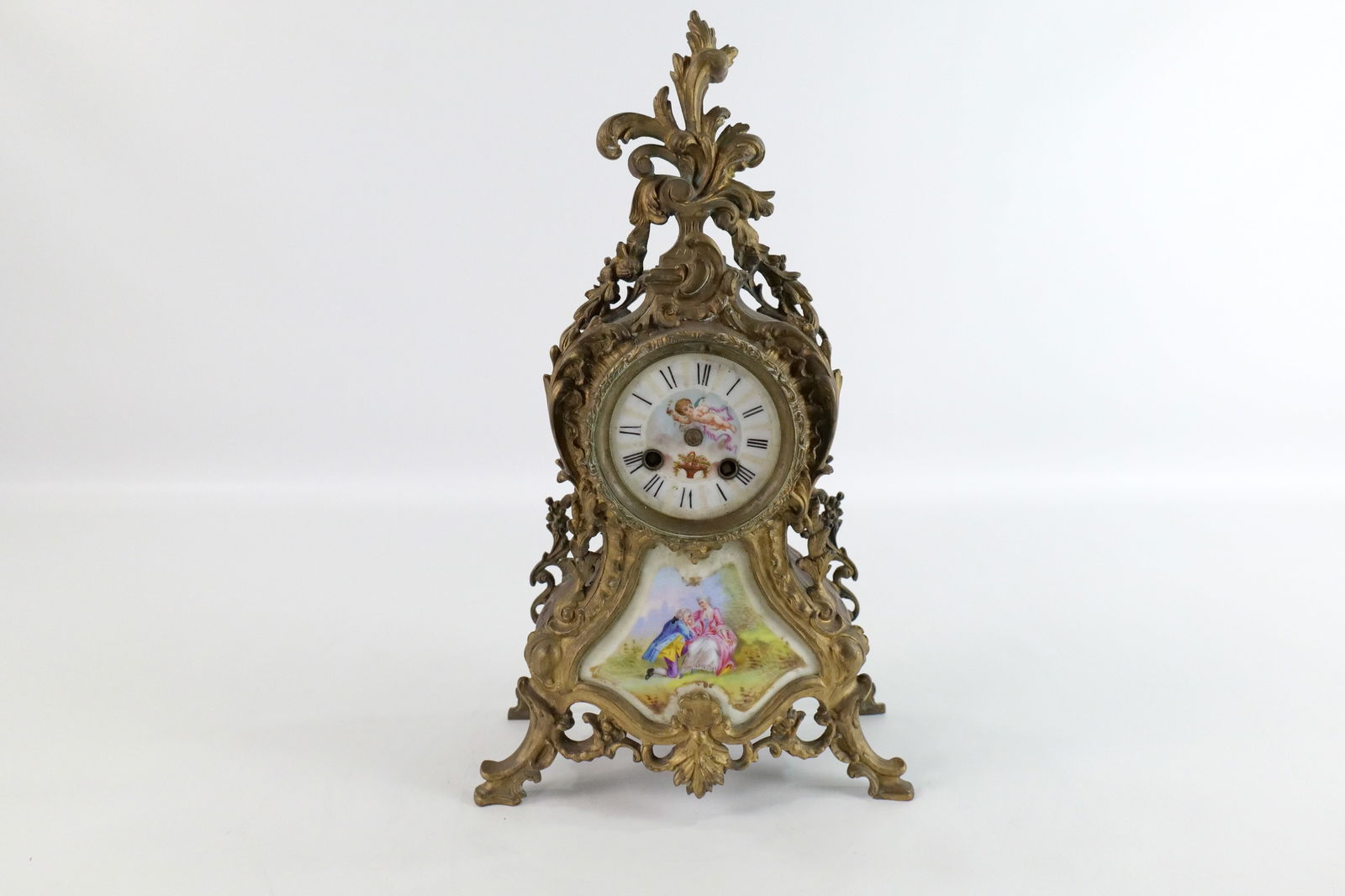 Antique French Bronze Mantle Clock: Antique French Bronze Mantle Clock. Has hand painted porcelain front and dial. Missing front crystal, clock hands, missing pendulum and works have rust. Measures 16.5" tall x 10" wide. All invoices mu