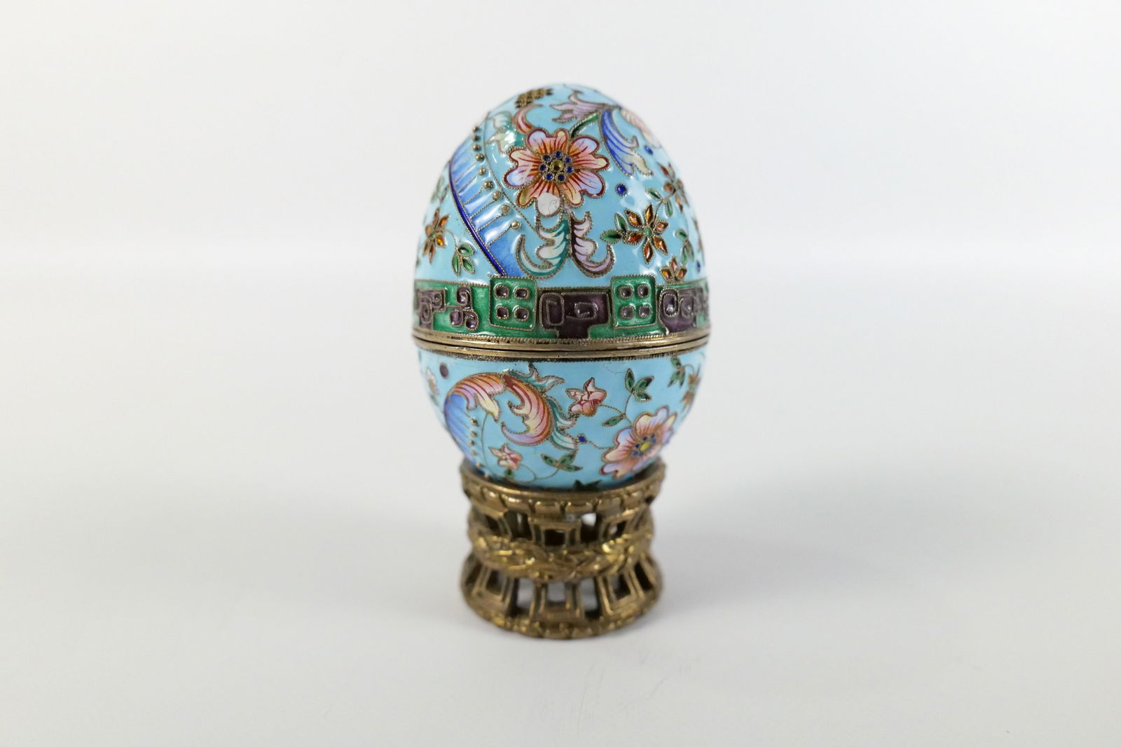 Russian Silver and Enamel Faberge Style Decorative Egg Box: Russian Silver and Enamel Faberge Style Decorative Egg Box. Flower Decoration. Unmarked. Has gold wash on the inside of the egg. Comes with Stand - Not original to egg. Measures 2.5" tall x 2" diamete