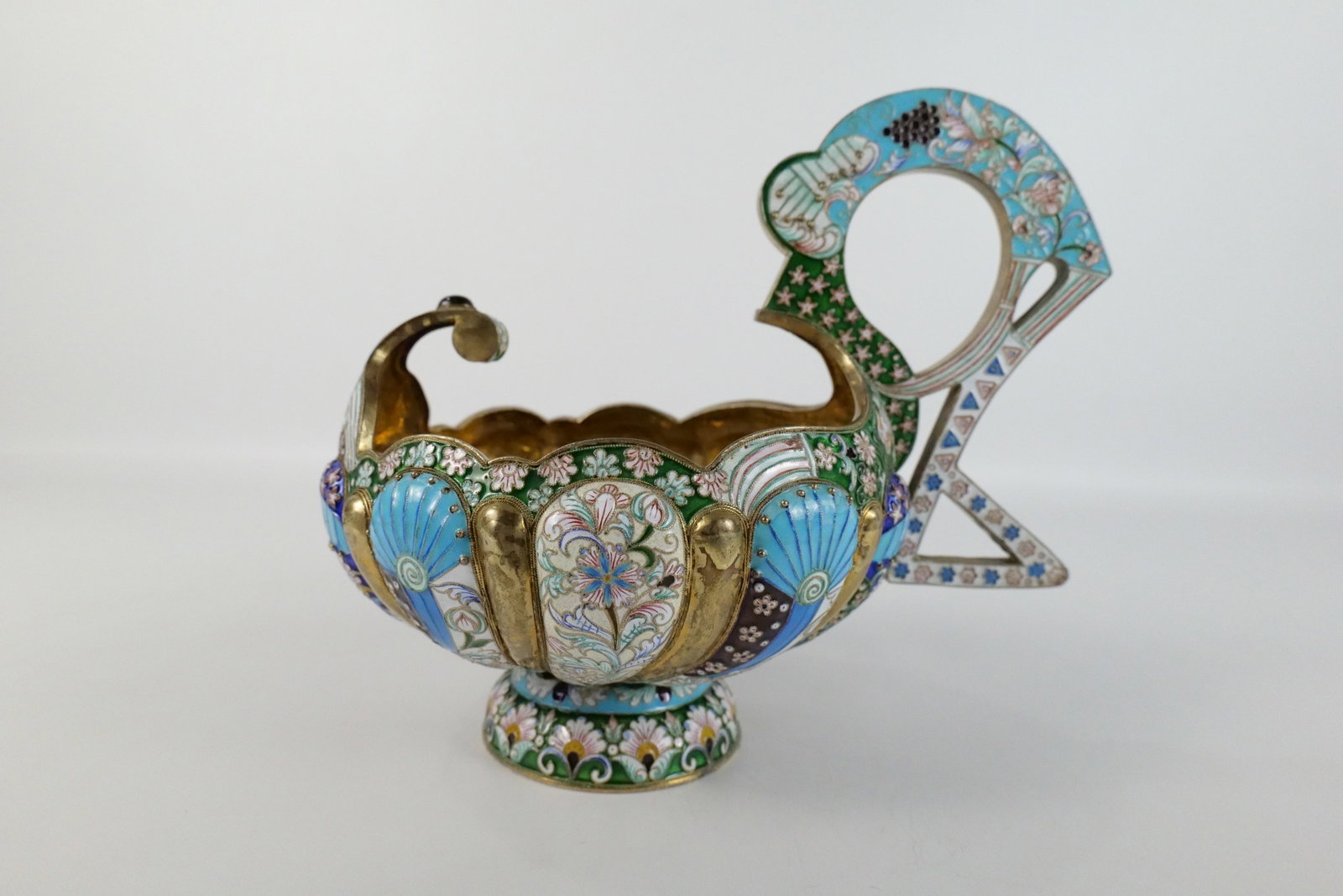 Russian Silver and Enamel Faberge Style Kovsh: Russian Silver and Enamel Faberge Style Kovsh. Flower and Grape Decoration. Gold Wash on Inside. Marked with a Head and a number 84. Oversized with Large Handle. Measures 8.5" tall x 10.5" long x 7" w