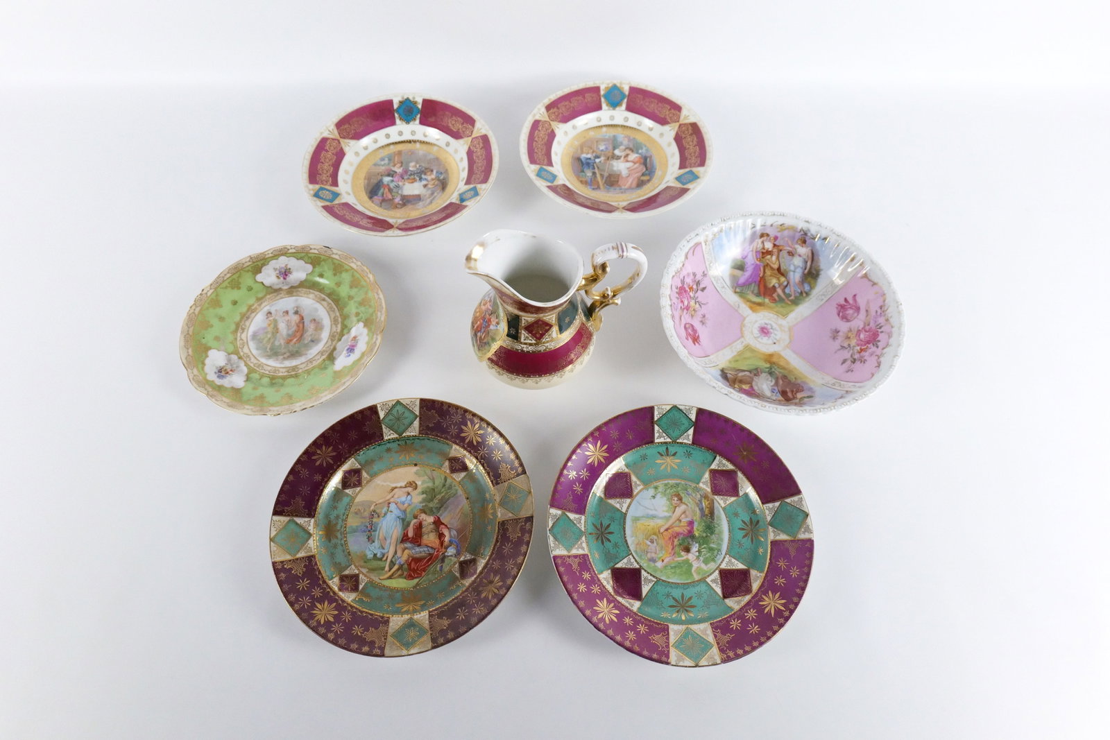 Group Lot of Antique Royal Vienna Porcelain: Group Lot of Antique Royal Vienna Porcelain - Hand Painted and Transferware. Including Pitcher, Serving Bowl, (2) Bowls - Some chips on the rims, and (3) Plates - Green plate has chips on rim and smal