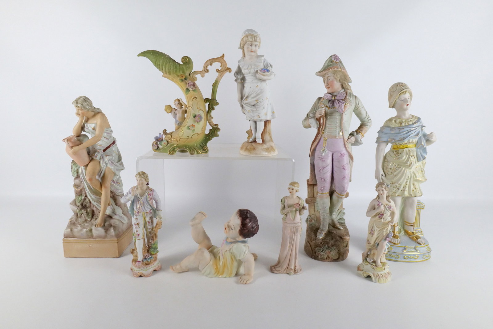 Group Lot of Porcelain and Bisque Figurines: Group Lot of Porcelain and Bisque Figurines including Vintage Ardult Japan Cherub Pitcher - Some Chips on Flowers, Roman Woman Figurine - Broken Fingers and piece off of chest, Oversized Gentlemen Fig