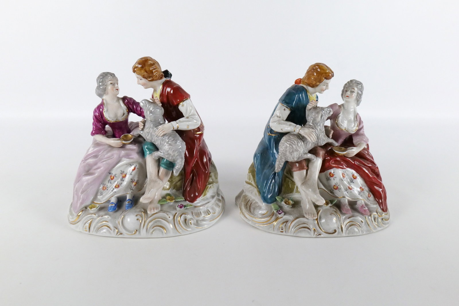 Set of 2 Hand Painted Porcelain Figurines: Set of 2 Hand Painted Porcelain Figurines - Occupied Japan. Depicting couples with goats. Both appear to be in good condition except for minor loss to the flowers on the base. Measures 7.5" tall x 8" 