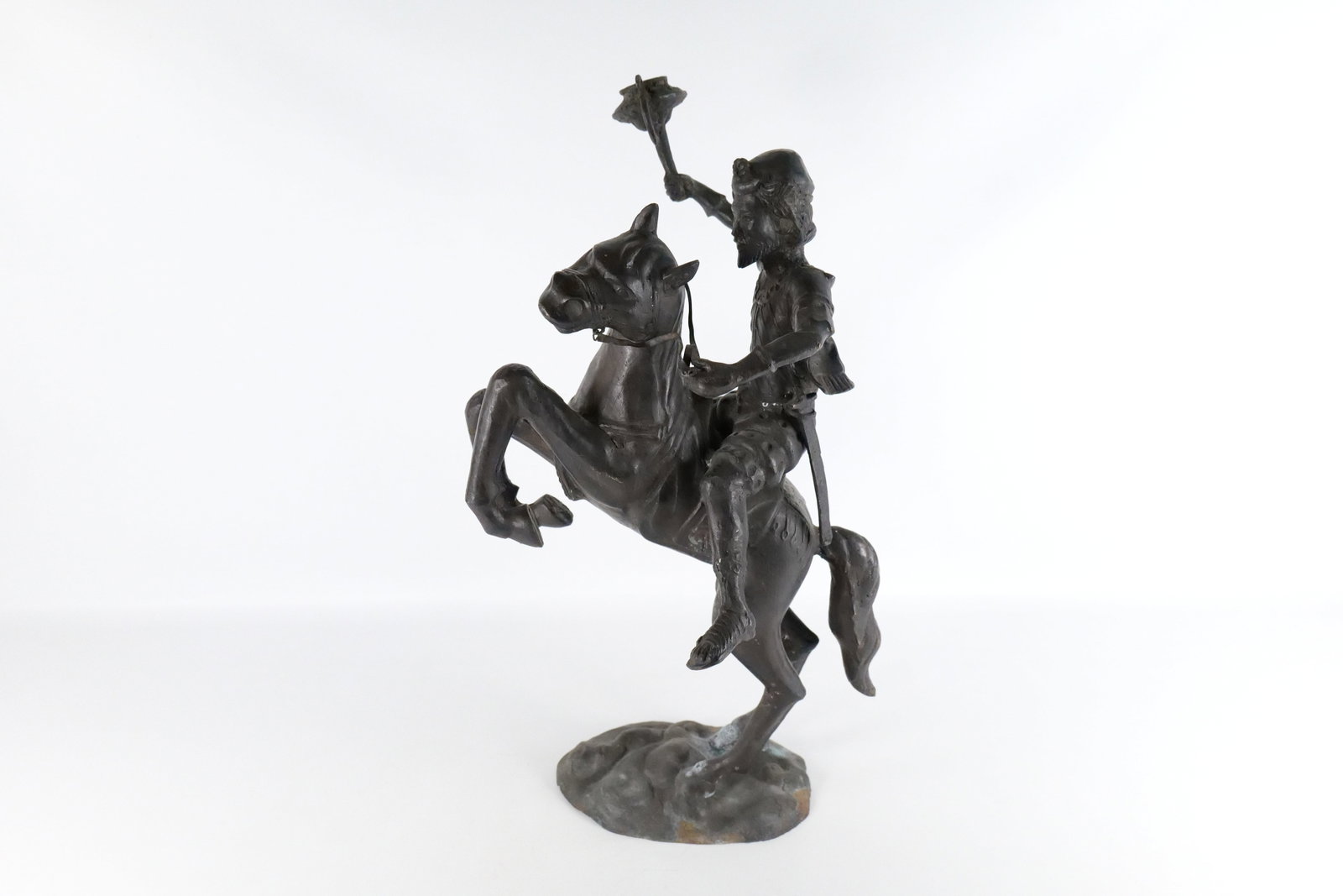 Mixed Metal Statue - Man on Horseback: Mixed Metal Statue depicting Man on Horseback holding a Torch. Some tarnishing on base. Comes with attachable sword. Measures 31" tall x 16" long. All invoices must be paid within 24 hours of the sale