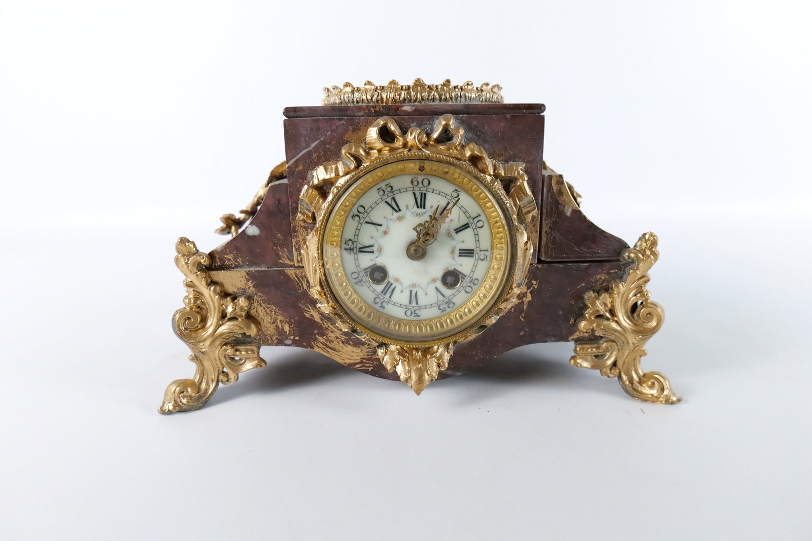 19th Century French Mantle Clock: 19th Century French Mantle Clock with Bronze Accents. Porcelain Face Dial. Works marked France with a French Makers Mark. Originally had a bronze sculpture on top - Missing. Measures 7" tall x 11" wid