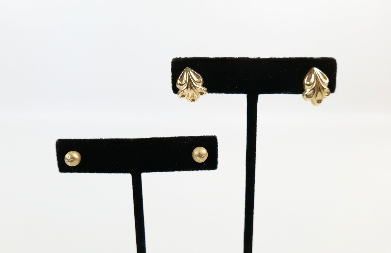 2 Pairs of 14K Stud Earrings: 2 Pairs of 14K Stud Earrings. The includes 2 pairs of 14K yellow gold stud earrings featuring a pair of .59'' x .43'' embossed looped patterned studs with post backs and a pair of 5.8mm gold ball stud