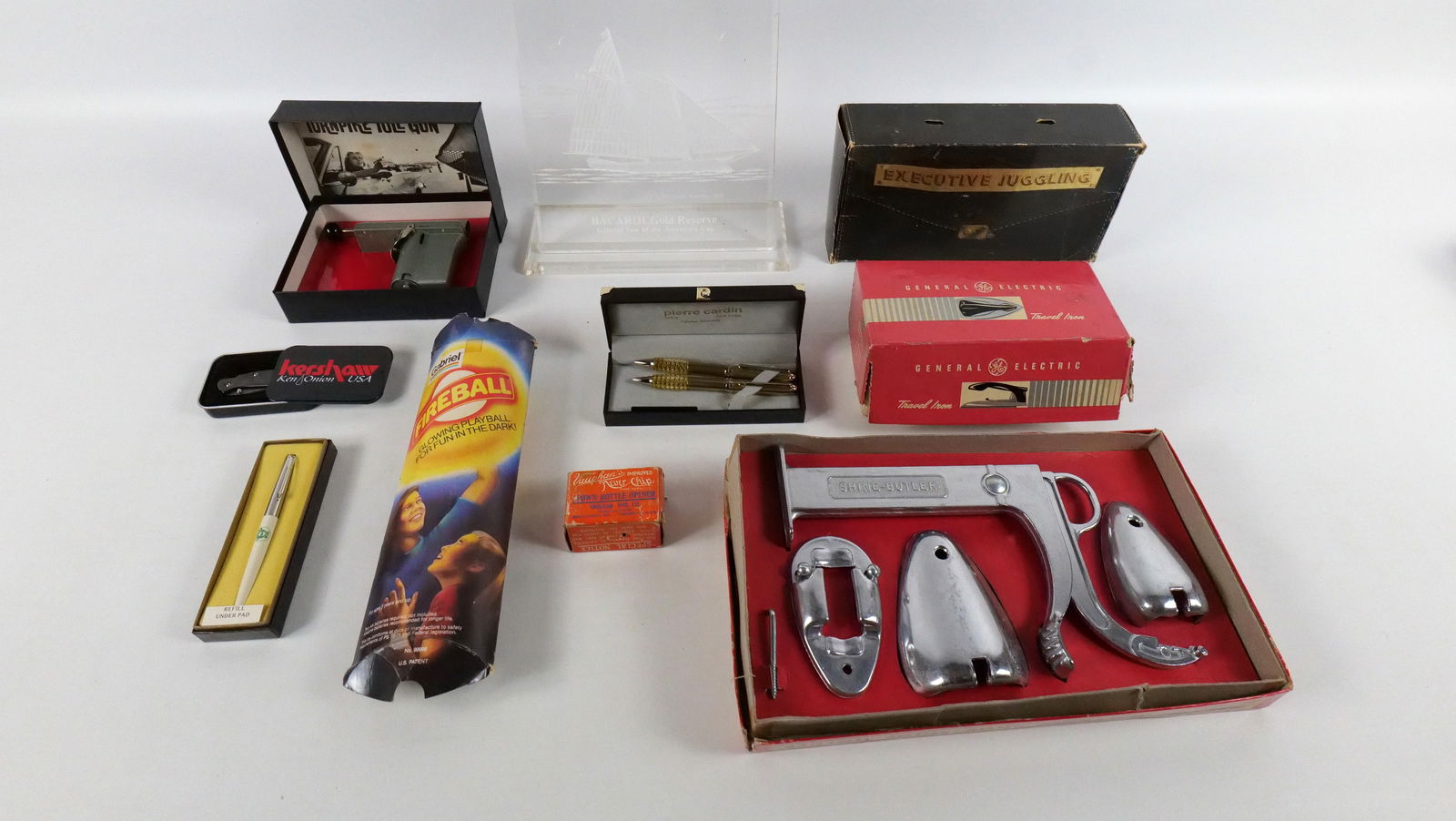 Lot of Vintage Collectibles: Lot of Vintage Collectibles including Shine Butler Shoe Shine Holder in Box, General Electric Travel Iron in Box, Turnpike Toll Gun in Box, Executive Juggling Balls in Box, and More. All invoices must