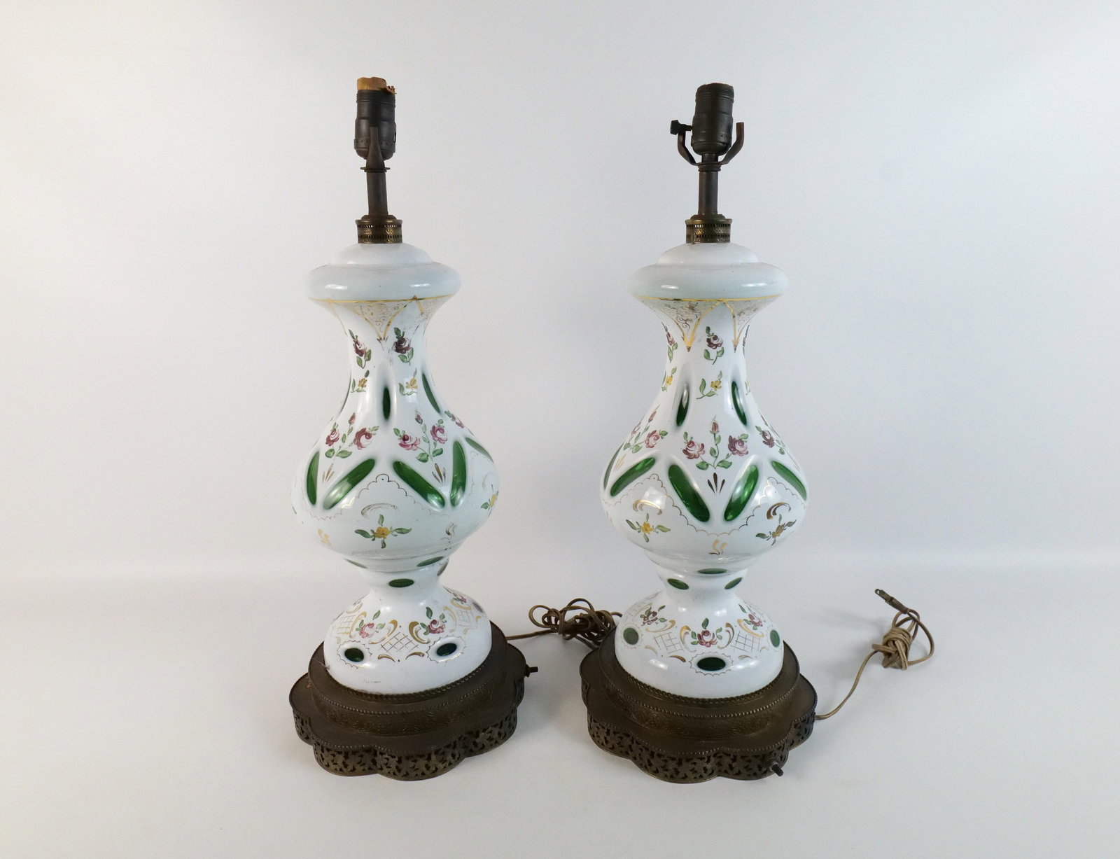 Pair of Bohemian Cut to Clear Lamps: Pair of Bohemian Cut to Clear Lamps with Hand Painted Accents. Comes on metal base. Good Condition. Measures 24" tall x 9.5" wide. All invoices must be paid within 24 hours of the sale. We offer multi