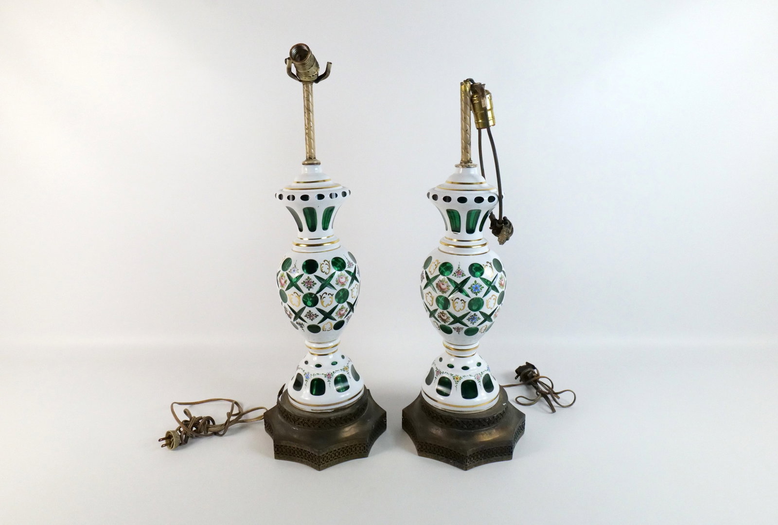 Pair of Bohemian Cut to Clear Lamps: Pair of Bohemian Cut to Clear Lamps with Hand Painted Accents. Comes on metal base. One metal base of the lamp is AS-IS. Otherwise the lamps are in good condition. Measures 27" tall x 8.5" wide. All i