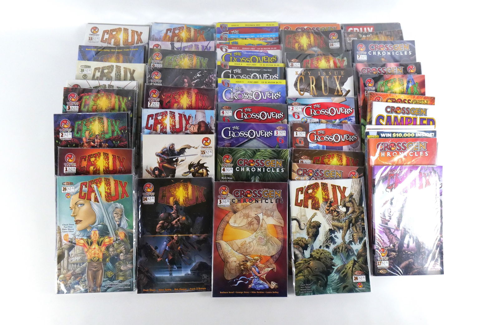 Lot of Mixed CrossGen Comics: Lot of Mixed CrossGen Comics - All start with the Letter "C" Comics. Titles include Crossgen Primer, Sampler, Crossgen Chronicles #1-8, The Crossovers #1-9, and Crux #1-26. The photographs do not show