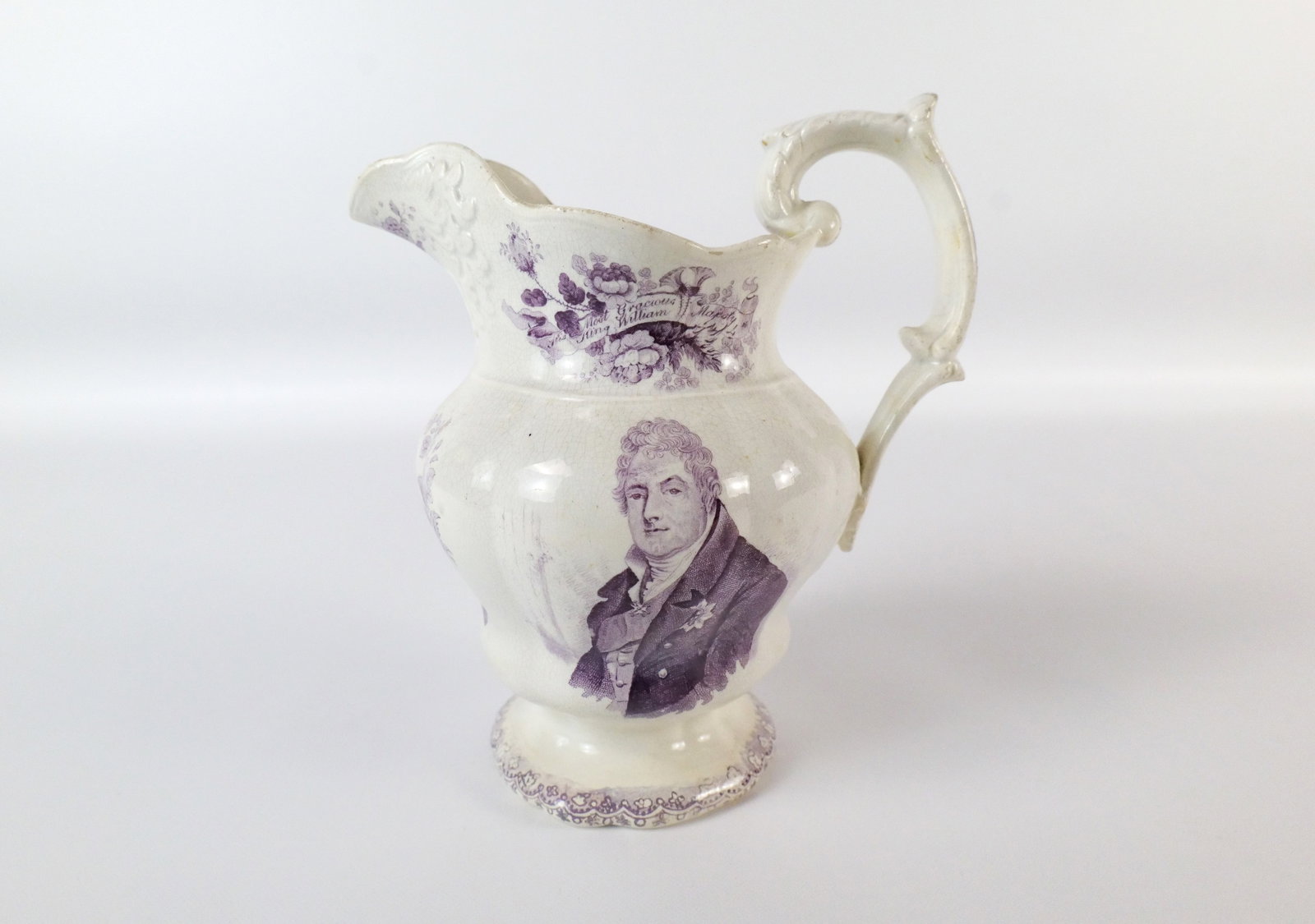 King William Queen Adelaide Pearlware Coronation Pitcher: King William the 4th and Queen Adelaide pearlware coronation pitcher. Done in a white pottery with a purple transfer and images of King William the 4th and "Our Beloved King William 4th" on one side a