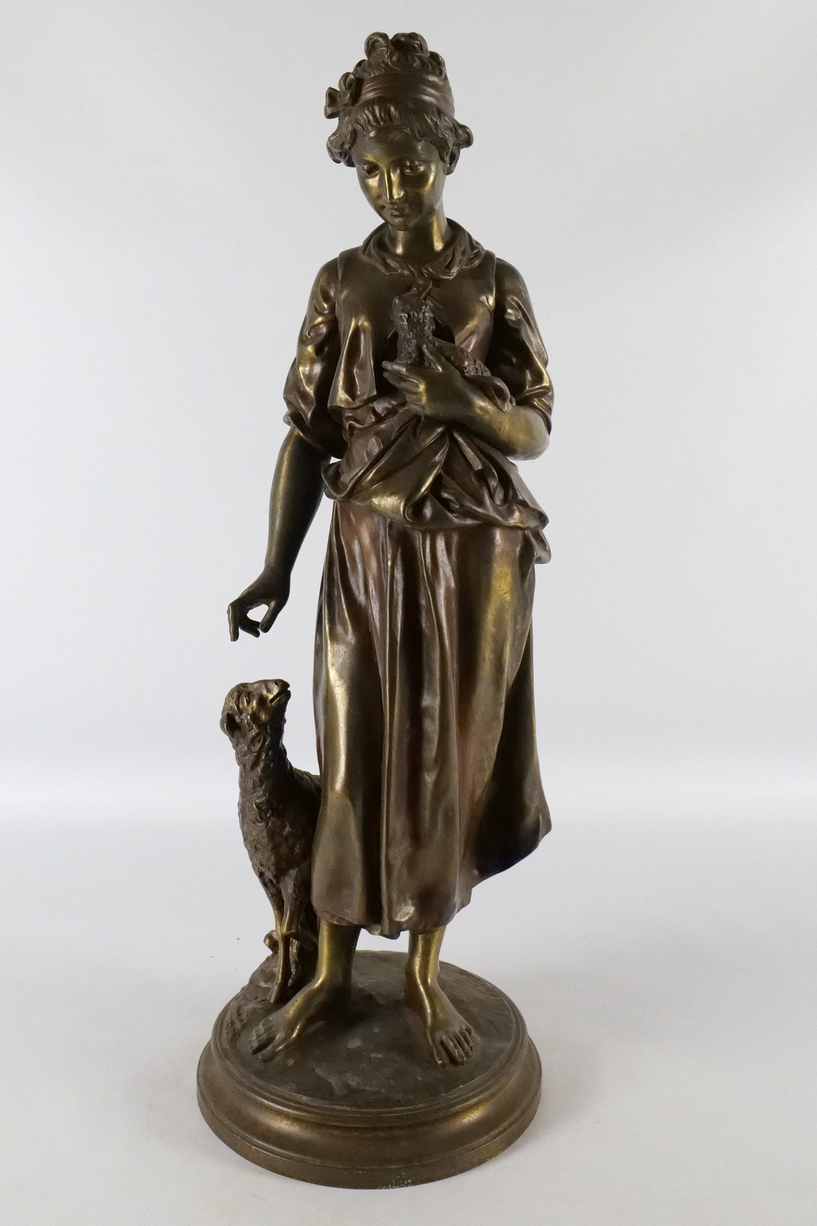 Bronze Statue - Woman with Sheep: Bronze Statue. Depicting a Woman with Sheep. After Pierre Louis Detrier. Circa mid 20th century. Measures 25" tall x 9" wide. All invoices must be paid within 24 hours of the sale. We offer multiple s