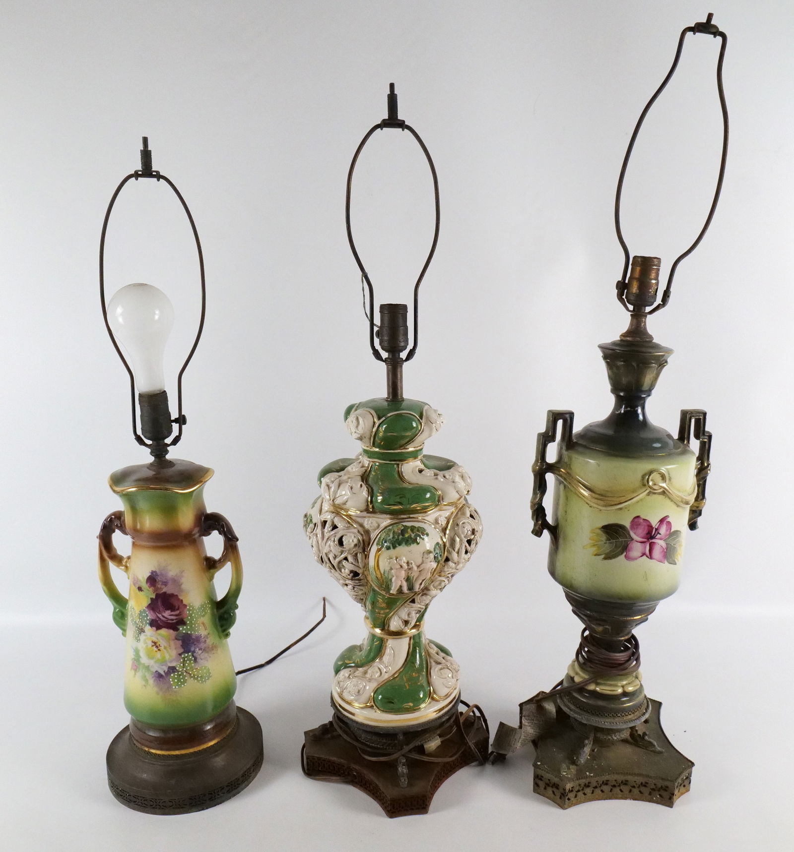 Group Lot of Table Lamps: Group Lot of Table Lamps. Including Capodimonte with Cherubs, Hand Painted Urn with Flowers, and Hand Painted Double Handled Vase with Flowers. Showing water damage on all the bases and all need to be