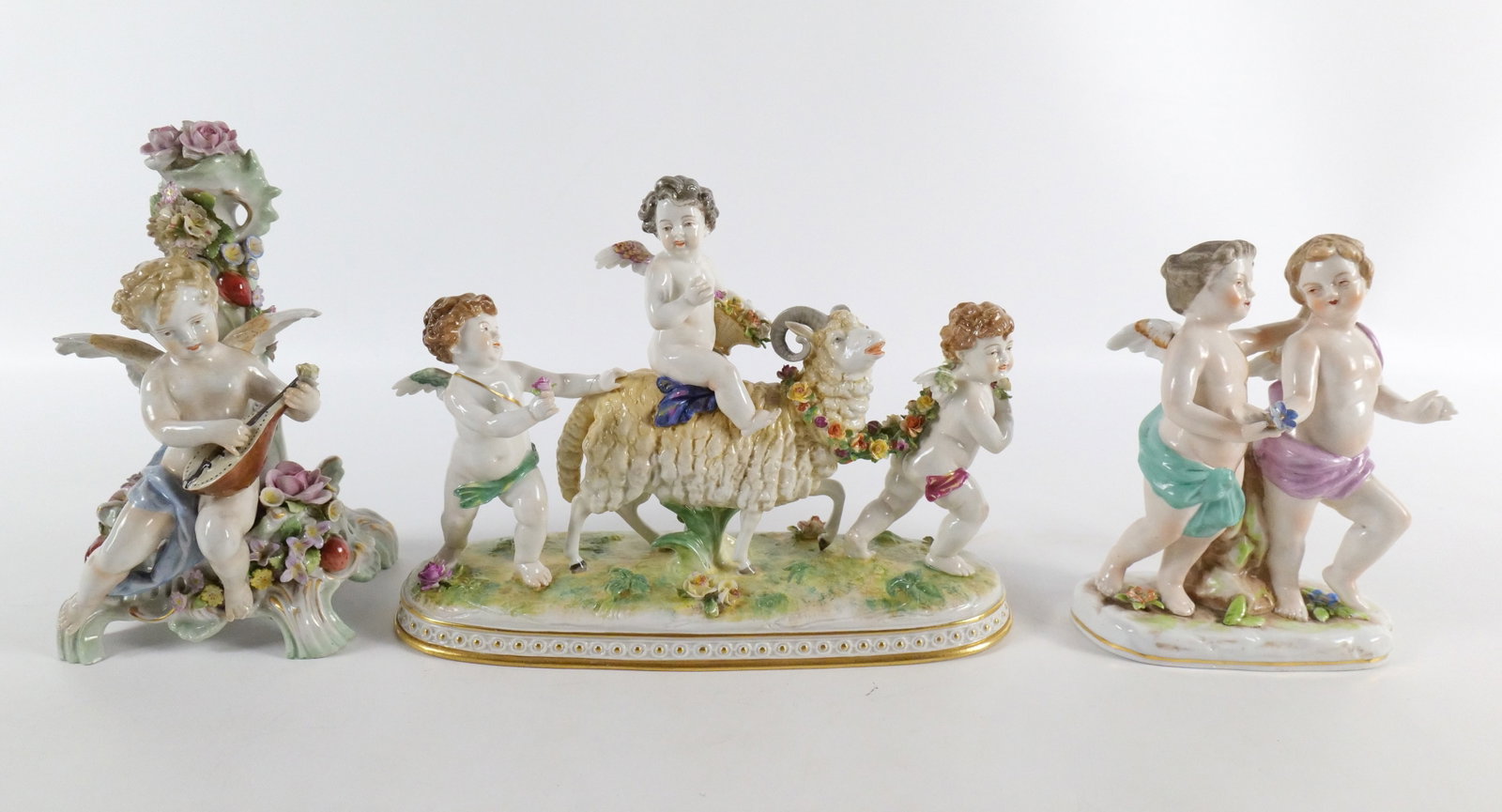 Lot of 3 Antique Hand Painted Porcelain Figurines: Lot of 3 Antique Hand Painted Porcelain Figurines including Figural Grouping of Putti's with a Goat - AS-IS - Arm has been repaired, missing basket handle, Some chips to flowers - Volkstedt Mark on ba