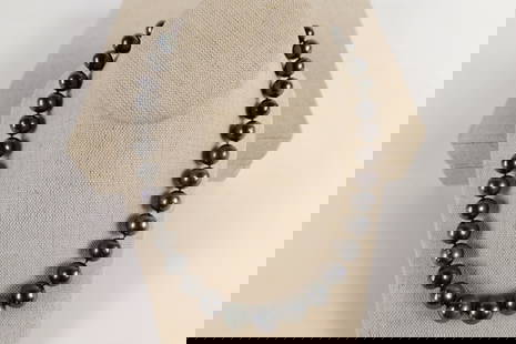 Tahitian Pearl Necklace: Tahitian Pearl Necklace. Contains 35 round cultured pearls measuring 11-14 mm. Finished with a scalloped 14K white gold plunger style bead clasp. Measures 18" long. Weighs approx. 87.9 grams. Comes wi