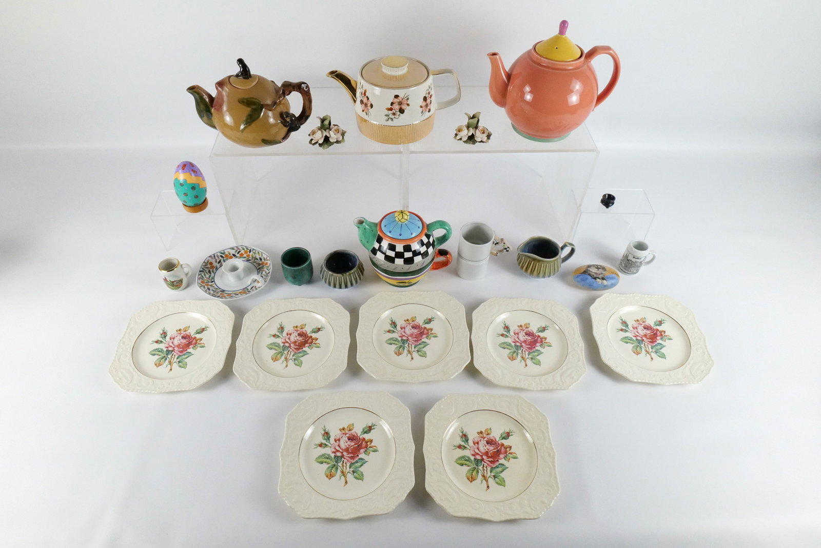 Group Lot of Porcelain Items: Group Lot of Porcelain Items. Including Tea for One Teapot - Chips on Base of the pot, Other Various Teapots, Wade Creamer and Sugar, Atlas China Porcelain Plates, Candlestick Holder and More. All inv