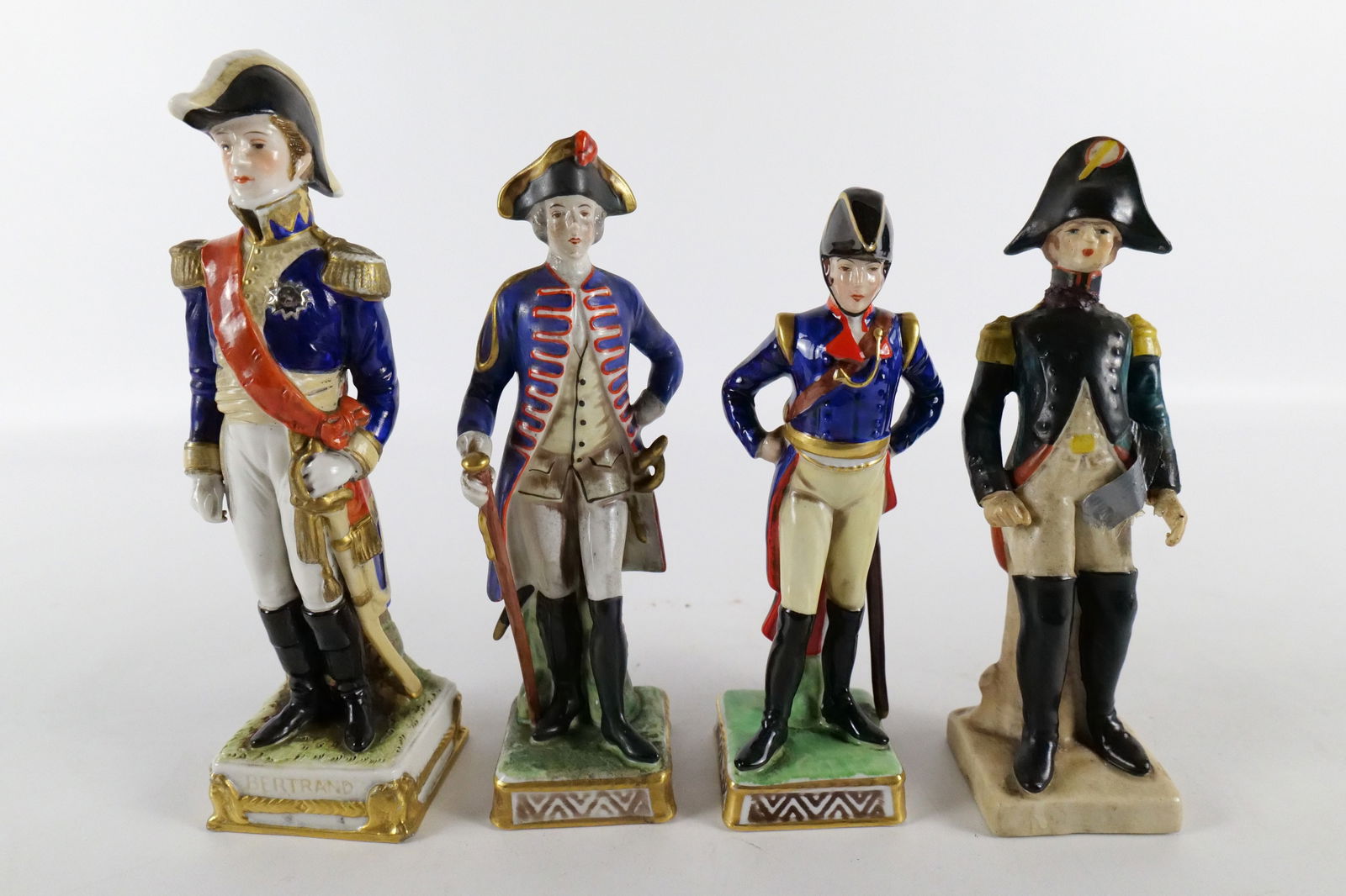 Lot of 4 Soldier Figurines: Lot of 4 Soldier Figurines. 2 Porcelain Marked Capodimonte - Some paint loss, Marked Germany Porcelain Figurine - appears to have some gold paint touch up, and Composition Soldier - Repair to head, mi